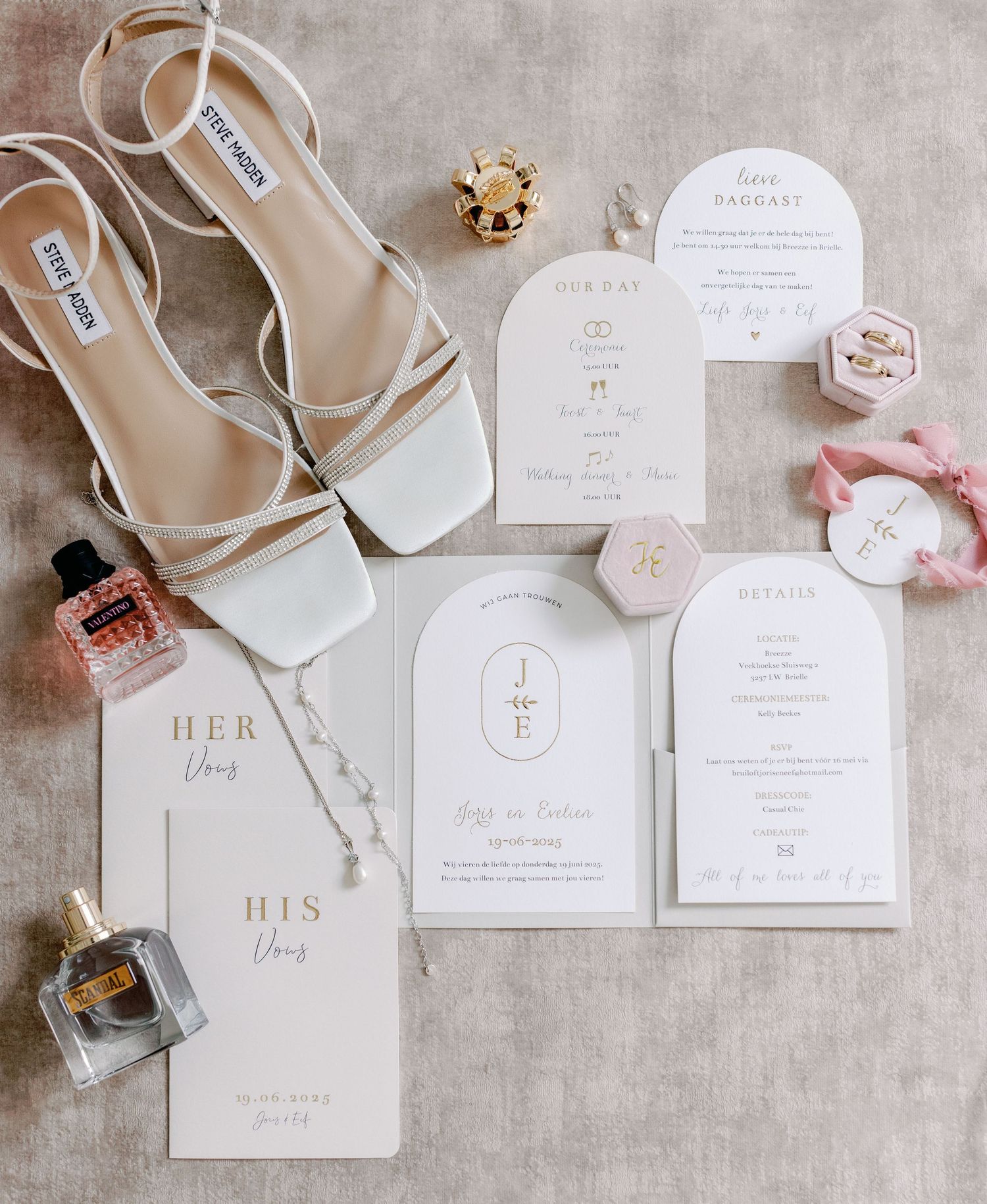 Elegant minimalist wedding stationery set in neutral tones with arch-shaped invitations.