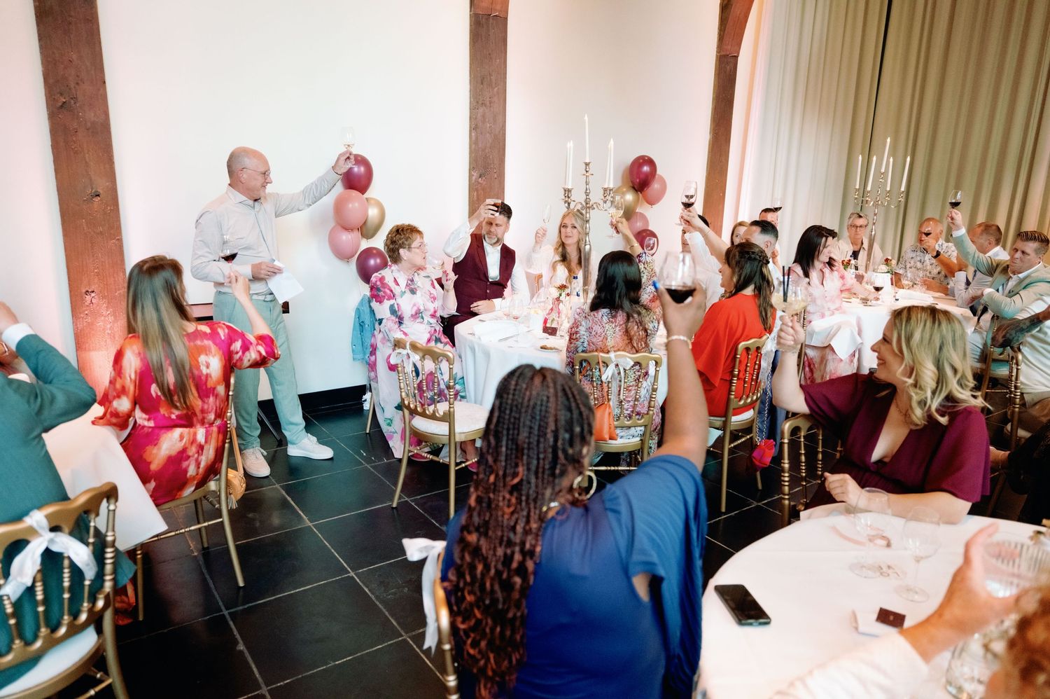 A panoramic collage of people socializing at a lively indoor event with drinks in hand.