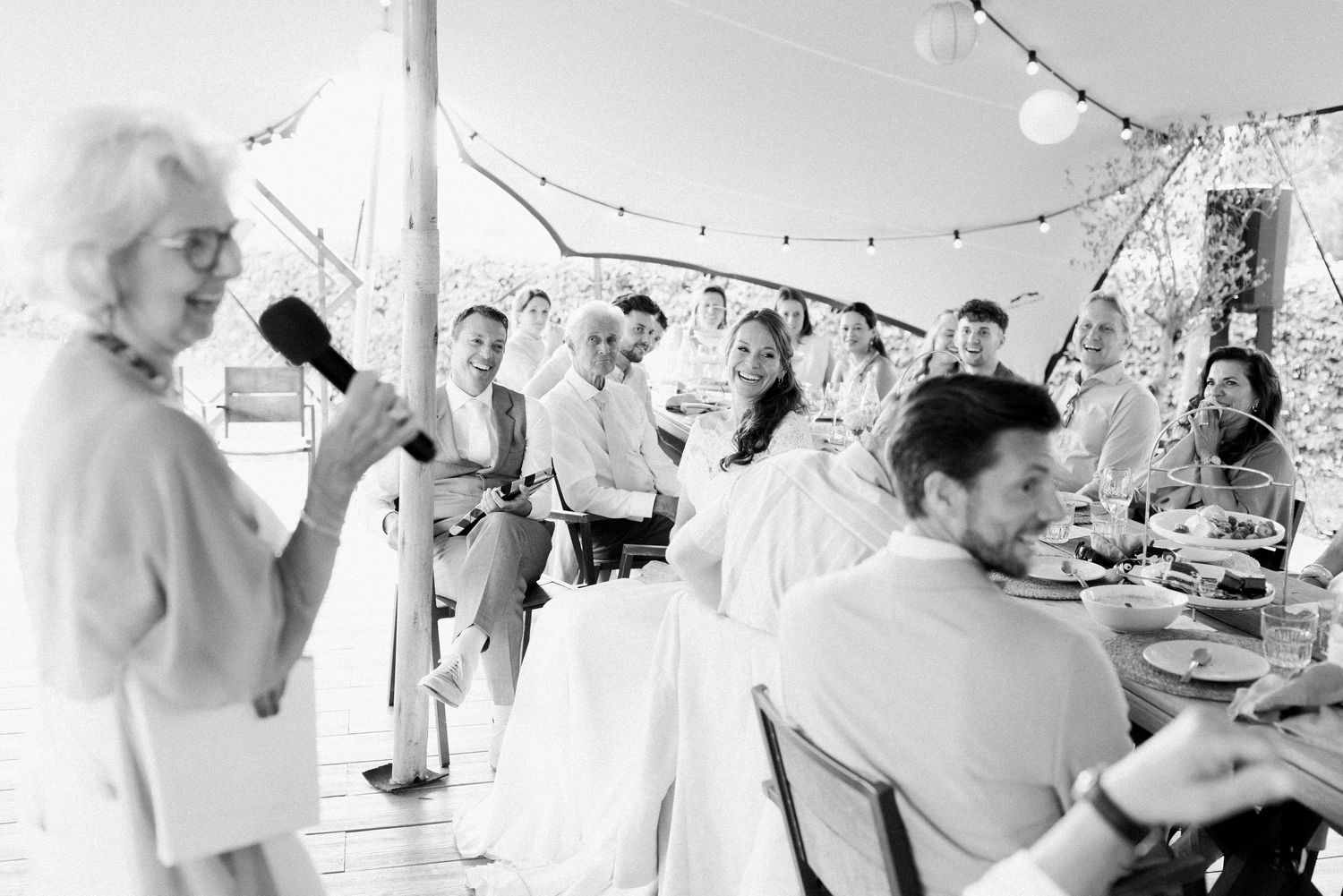 A series of black and white wedding reception photos showing guests dancing and celebrating at a festive party.