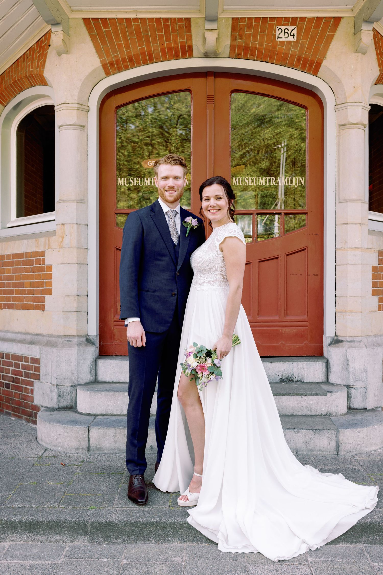 A romantic wedding photo series showing a couple posing together in front of a historic brick building entrance.