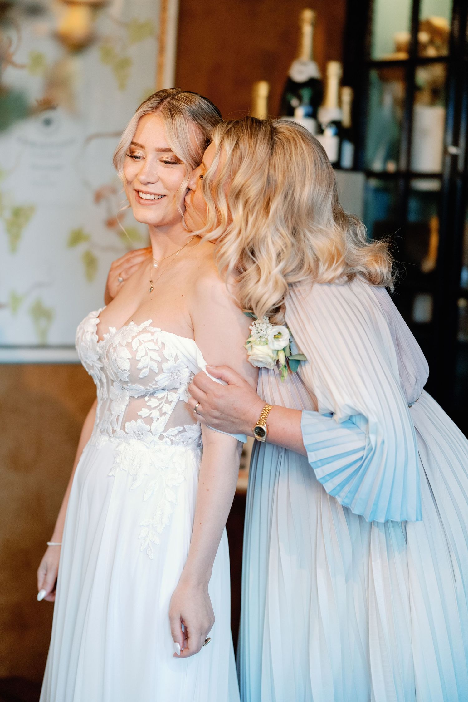 Four sequential photos show a tender moment between two people in formal attire, one in white and one in light blue.