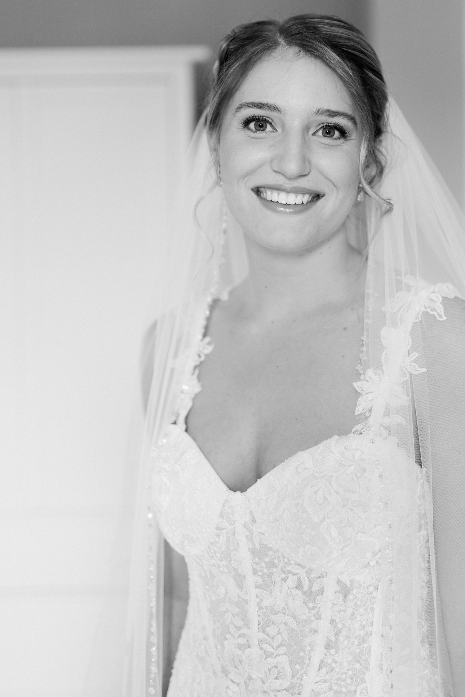 A bridal portrait series showing details of a white lace wedding gown and veil.