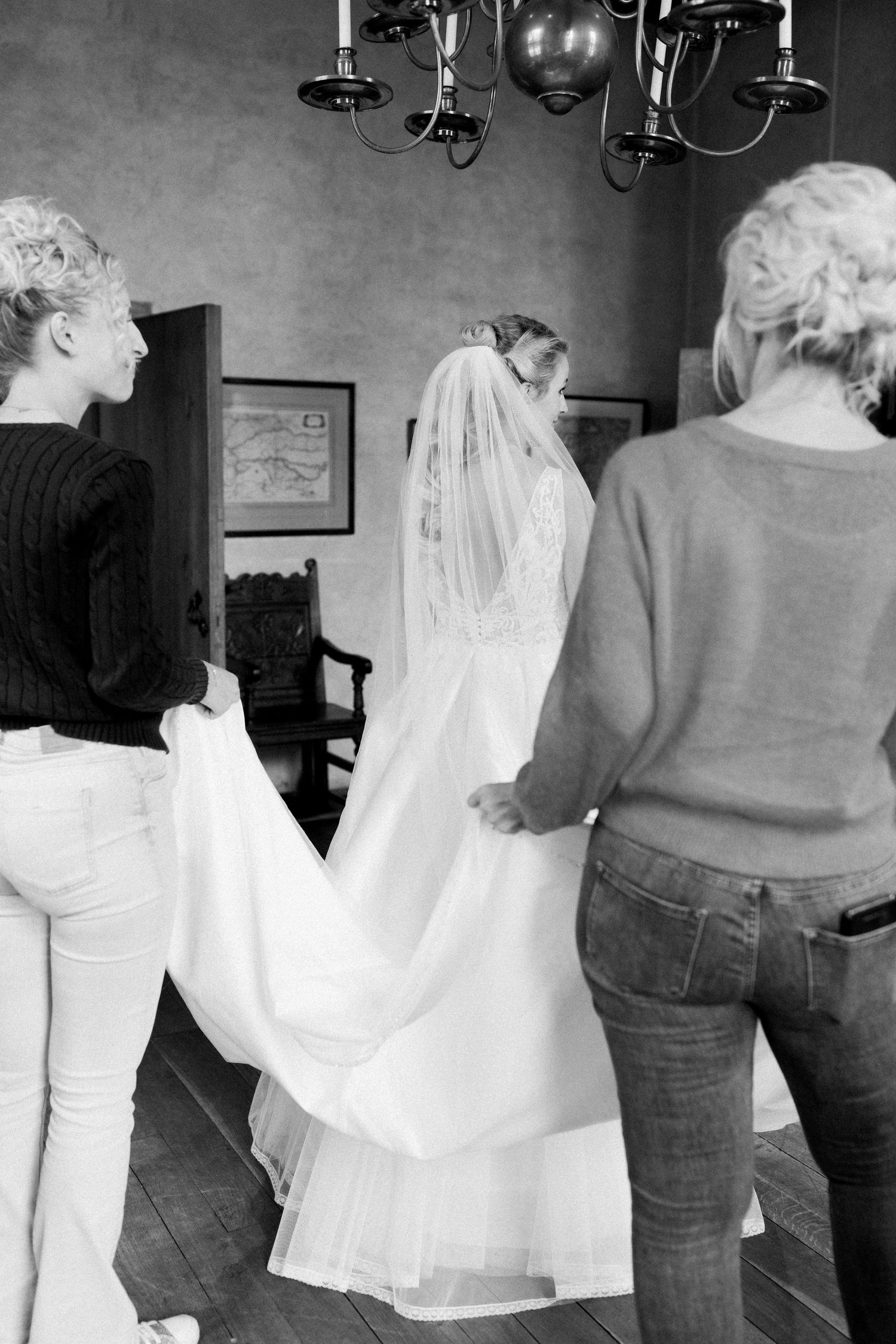 A black and white series of photos showing people dancing together in casual attire at a social gathering.