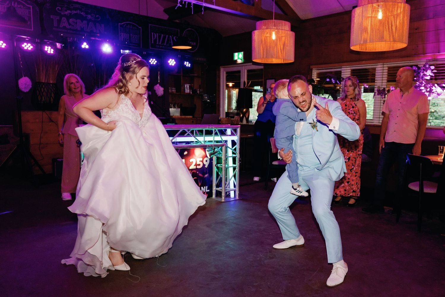 A sequence of dance floor moments at a wedding reception with purple and pink lighting creating a festive atmosphere.