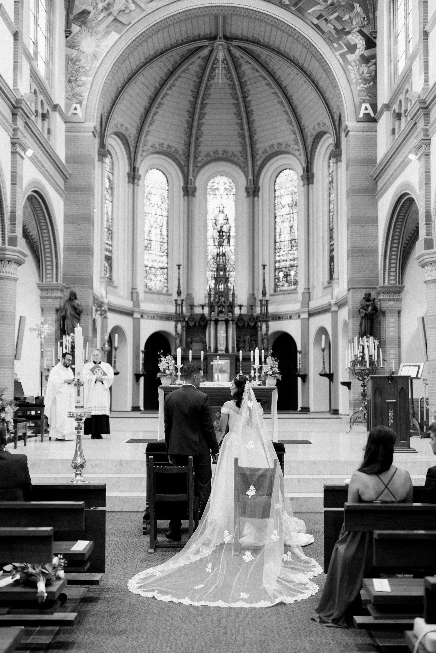 Black and white photos show a grand church interior with vaulted ceilings and stained glass windows.