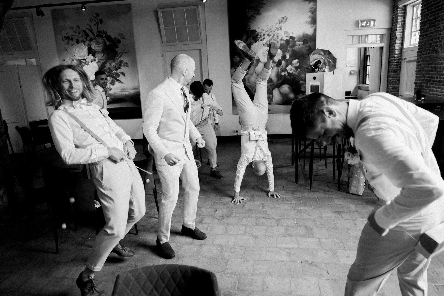 A sequence of black and white photos showing karate students practicing martial arts moves in a training studio.