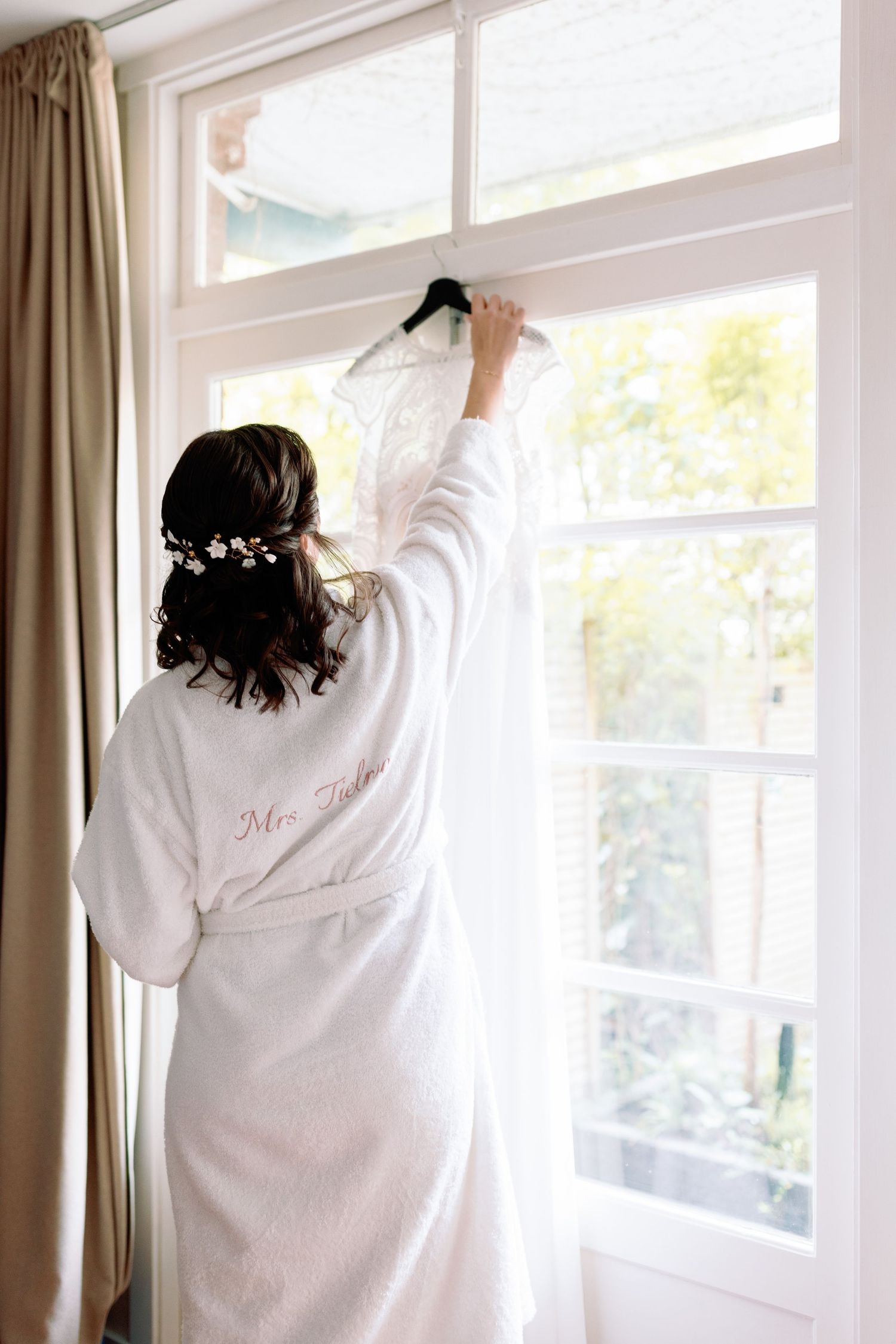 Someone wearing a white robe stands by bright windows in a series of similar photos showing their back.