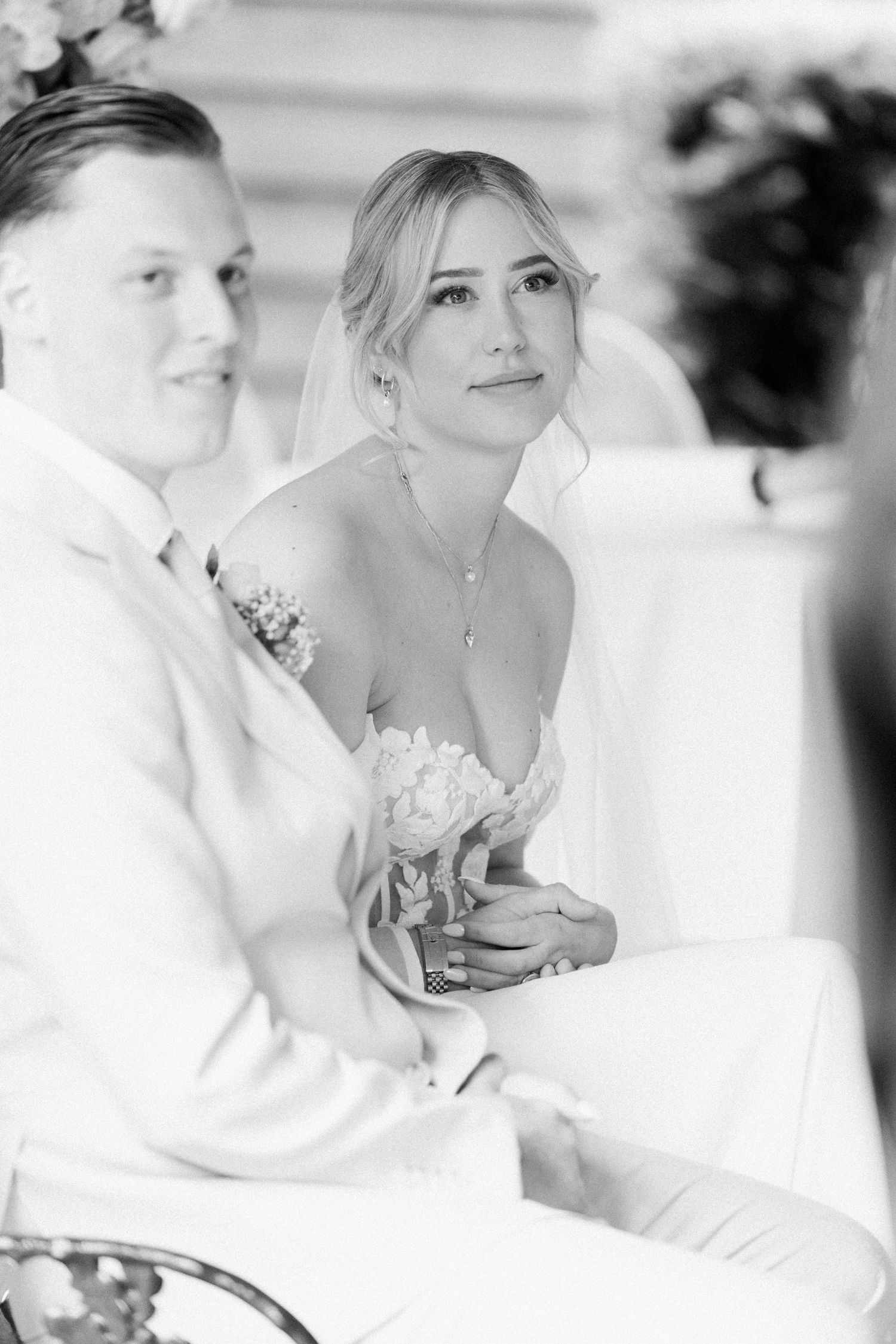 A romantic black and white wedding photo series showing tender moments between the couple.
