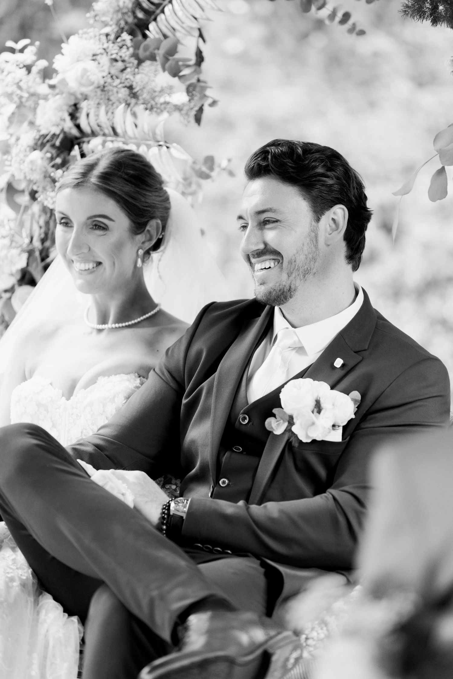 Black and white wedding photo sequence showing joyful candid laughter and reactions between a couple and guests outdoors.