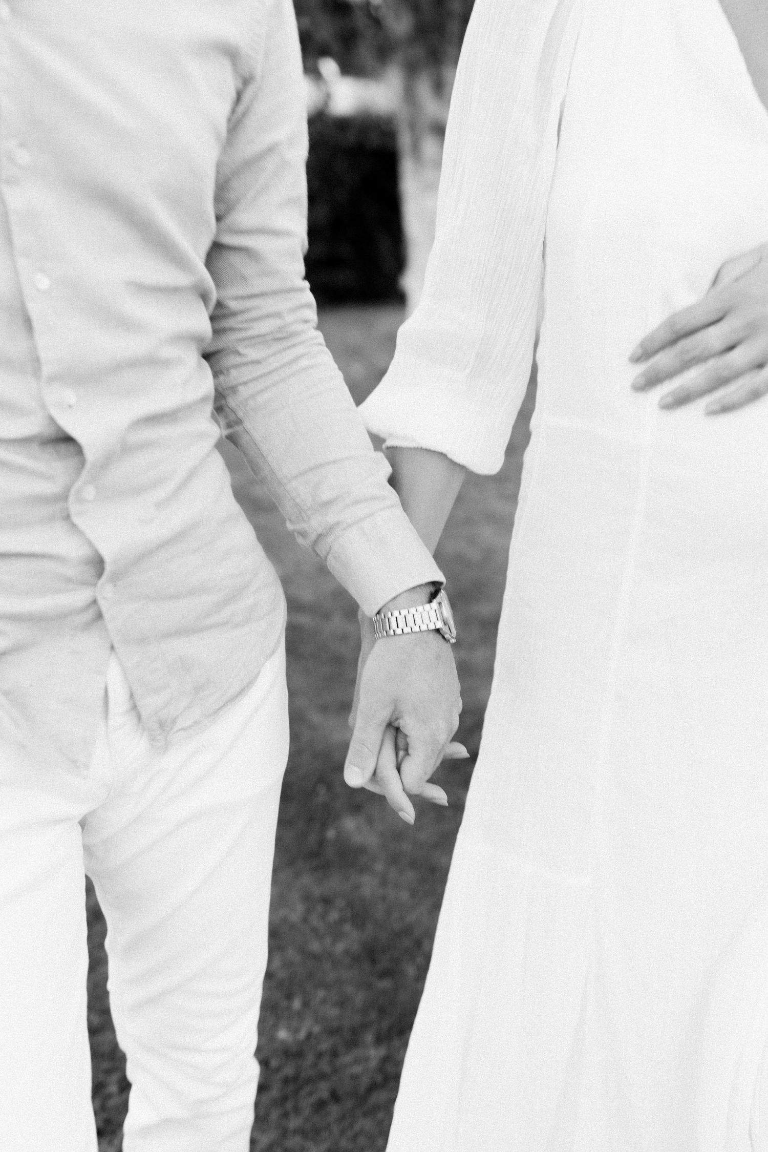 A black and white photo showing people wearing all white outfits standing together.