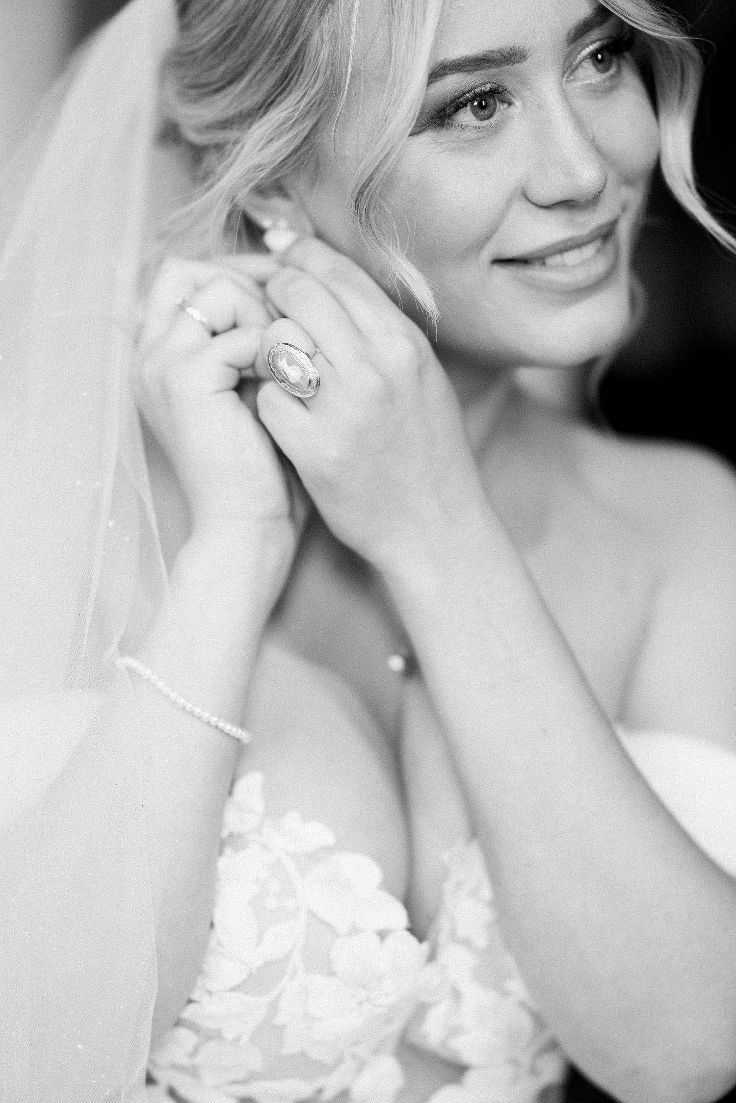 A black and white photo series shows close-up details of a bride getting ready with elegant jewelry and lace dress details.