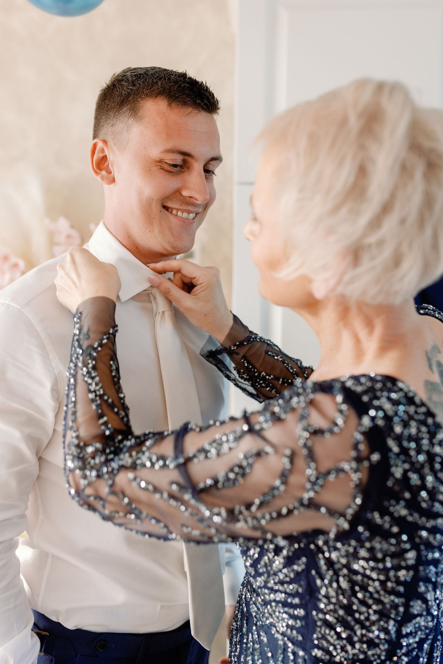 Sweet moment shared between two people in formal attire during a wedding celebration.