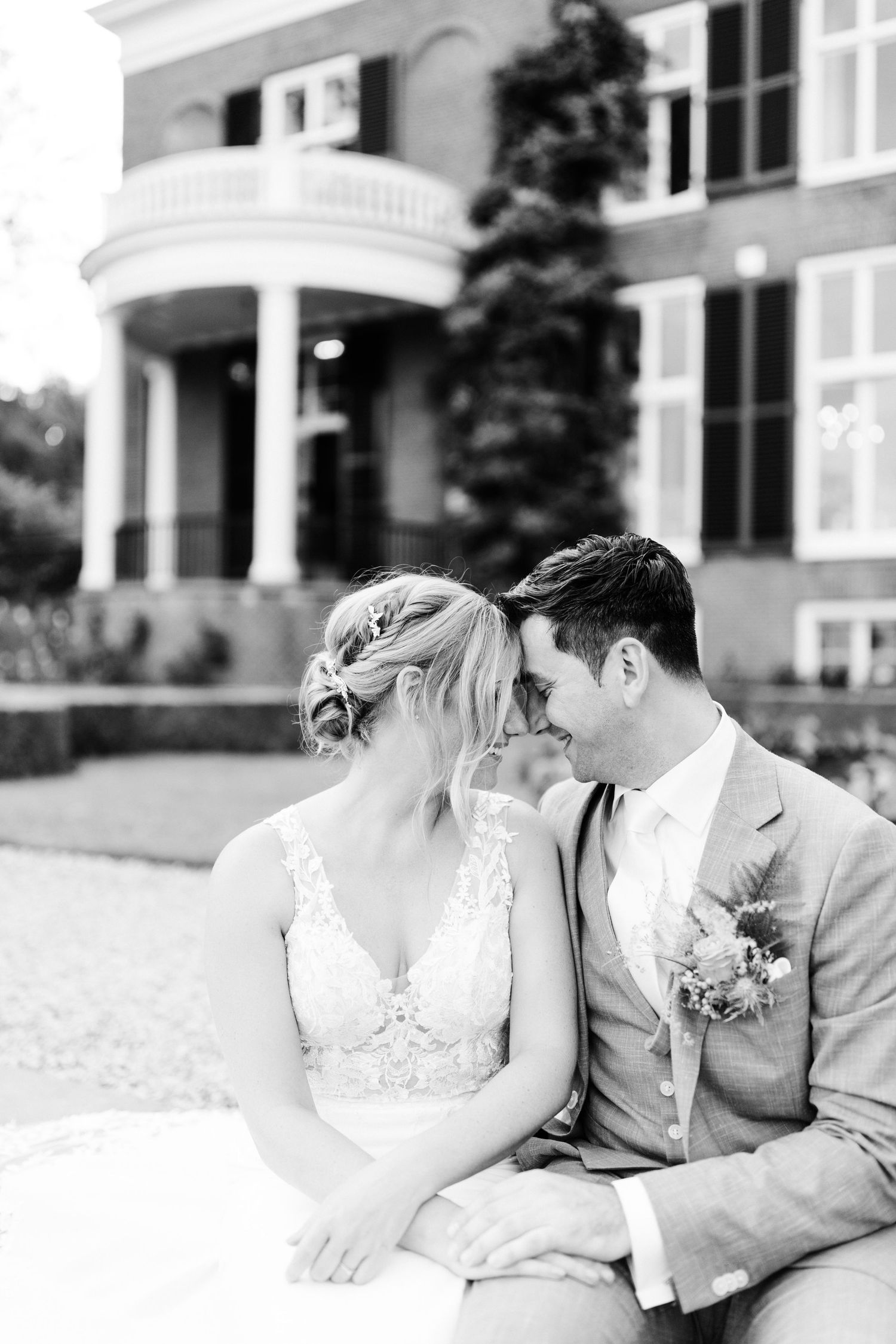 A romantic black and white photo series showing tender moments between a bride and groom on their wedding day.