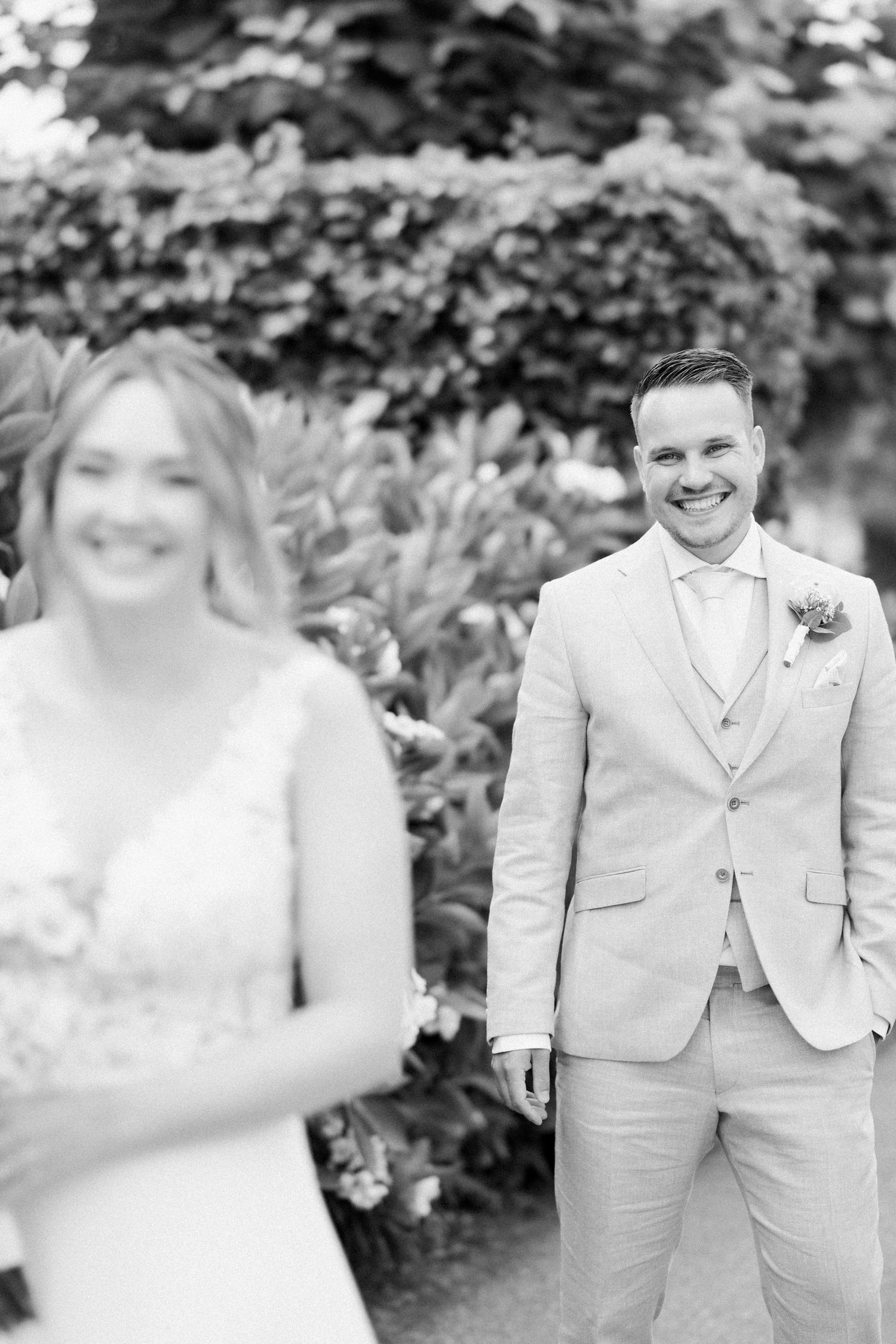 Black and white wedding photos showing a couple in formal attire posing together in a garden setting.