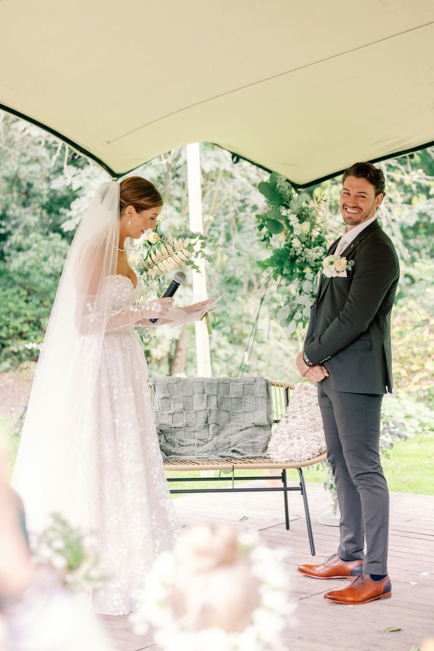 A series of outdoor wedding ceremony photos showing tender moments between the couple under a covered pavilion.