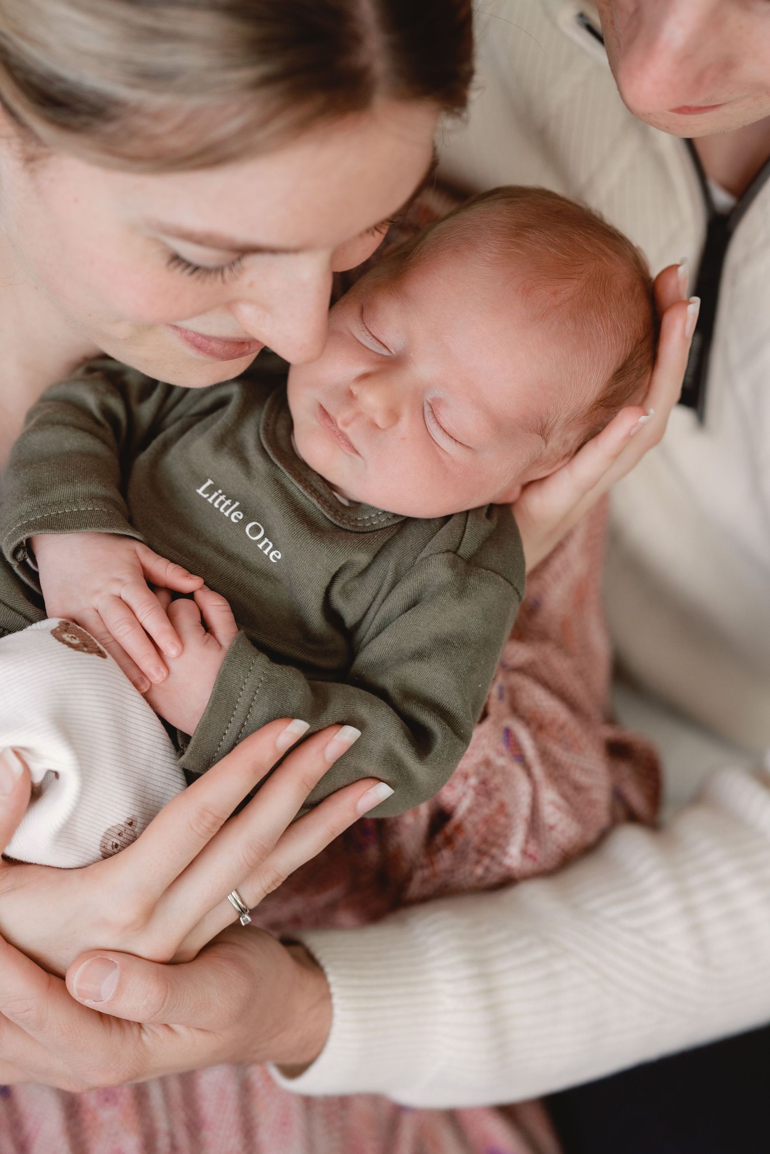 A series of intimate close-up shots showing tender moments between parent and baby in soft, muted tones.