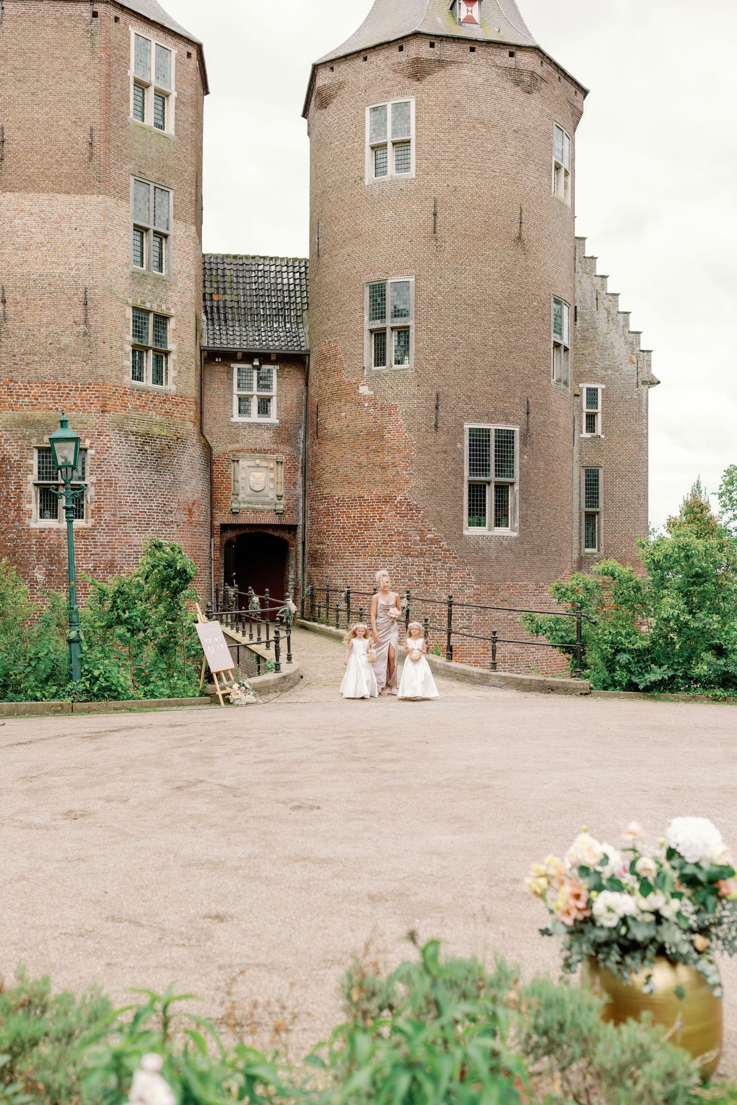 A sequence of photos showing a brick castle-like building exterior with green foliage and flowers in the foreground.
