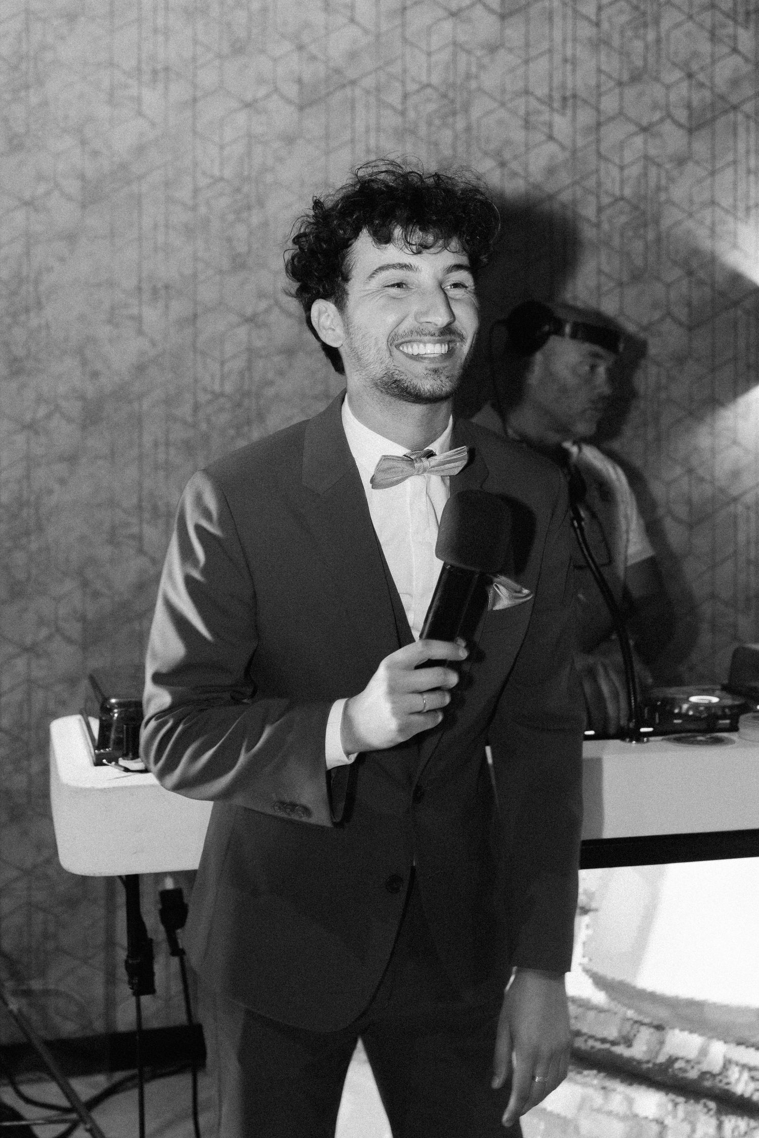 Speaker in formal attire delivering speech at reception.