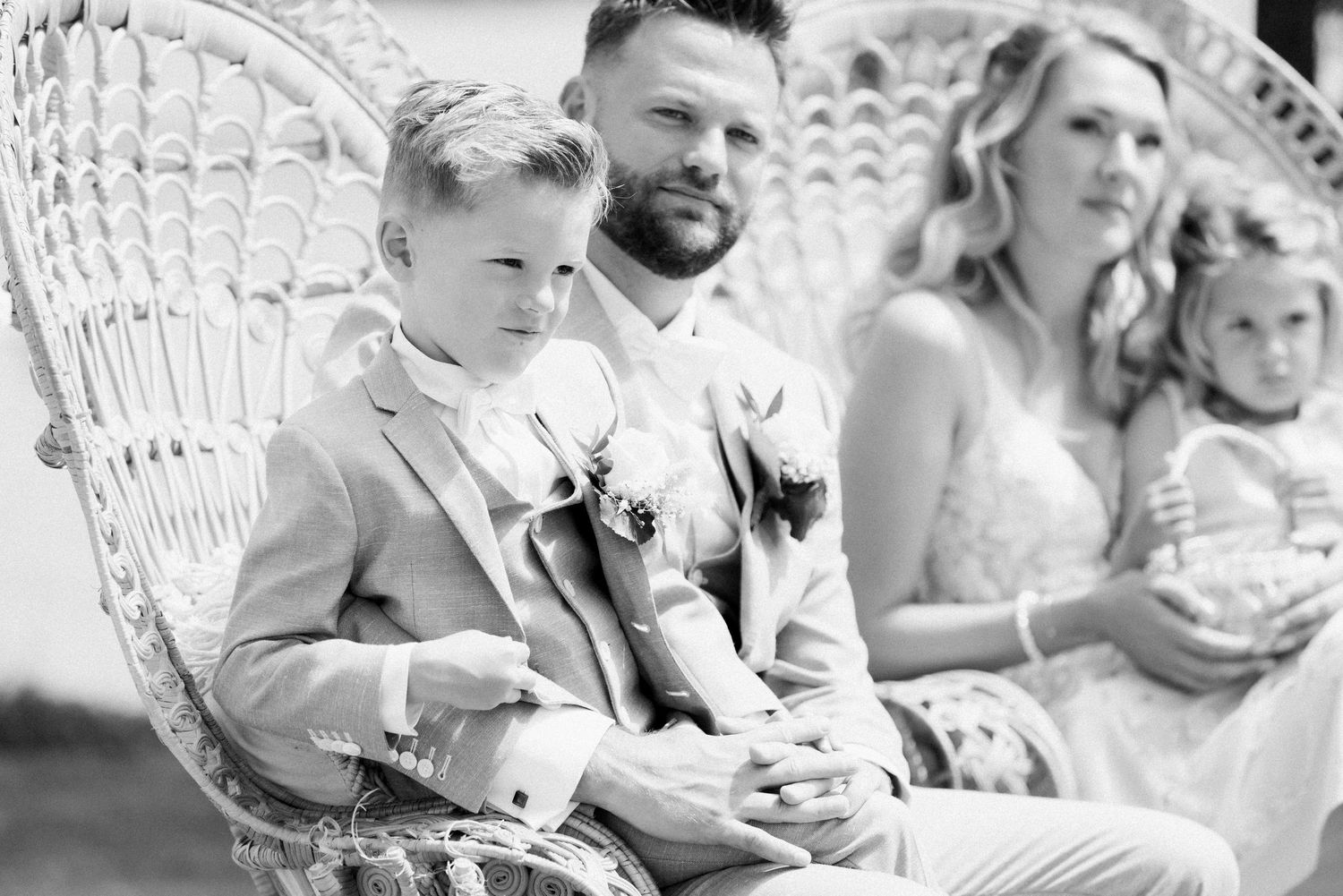 A series of black and white wedding photos showing candid moments during an outdoor celebration.