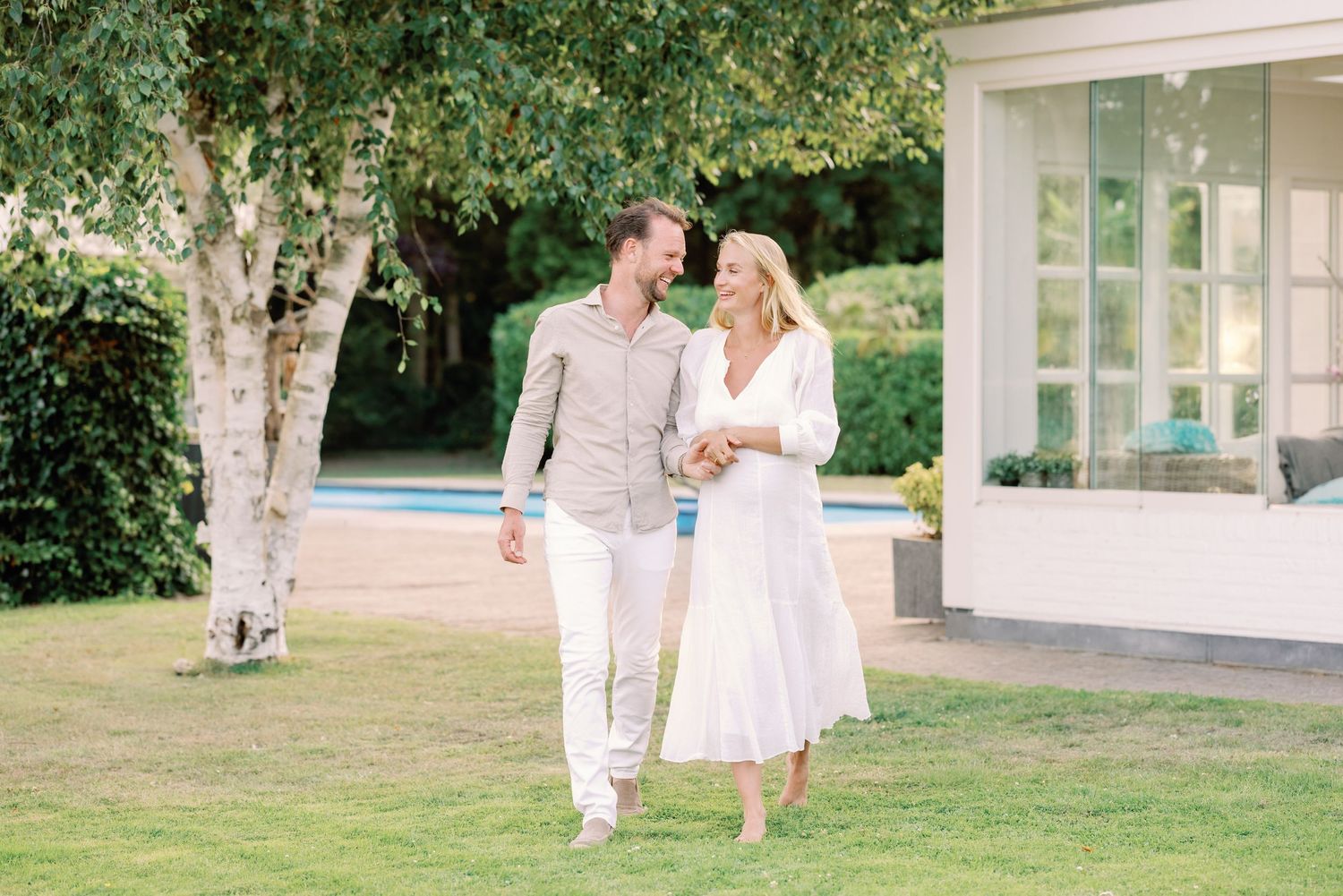 Romantic outdoor engagement session in a garden setting with natural light.
