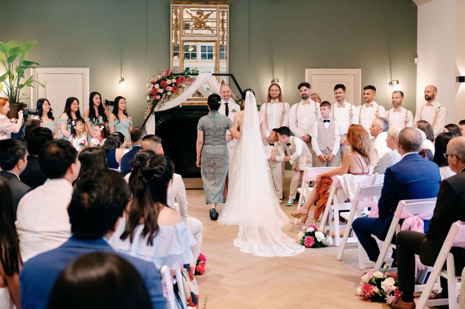 A panoramic collage of wedding celebration scenes showing guests, decor, and dancing in an indoor venue.