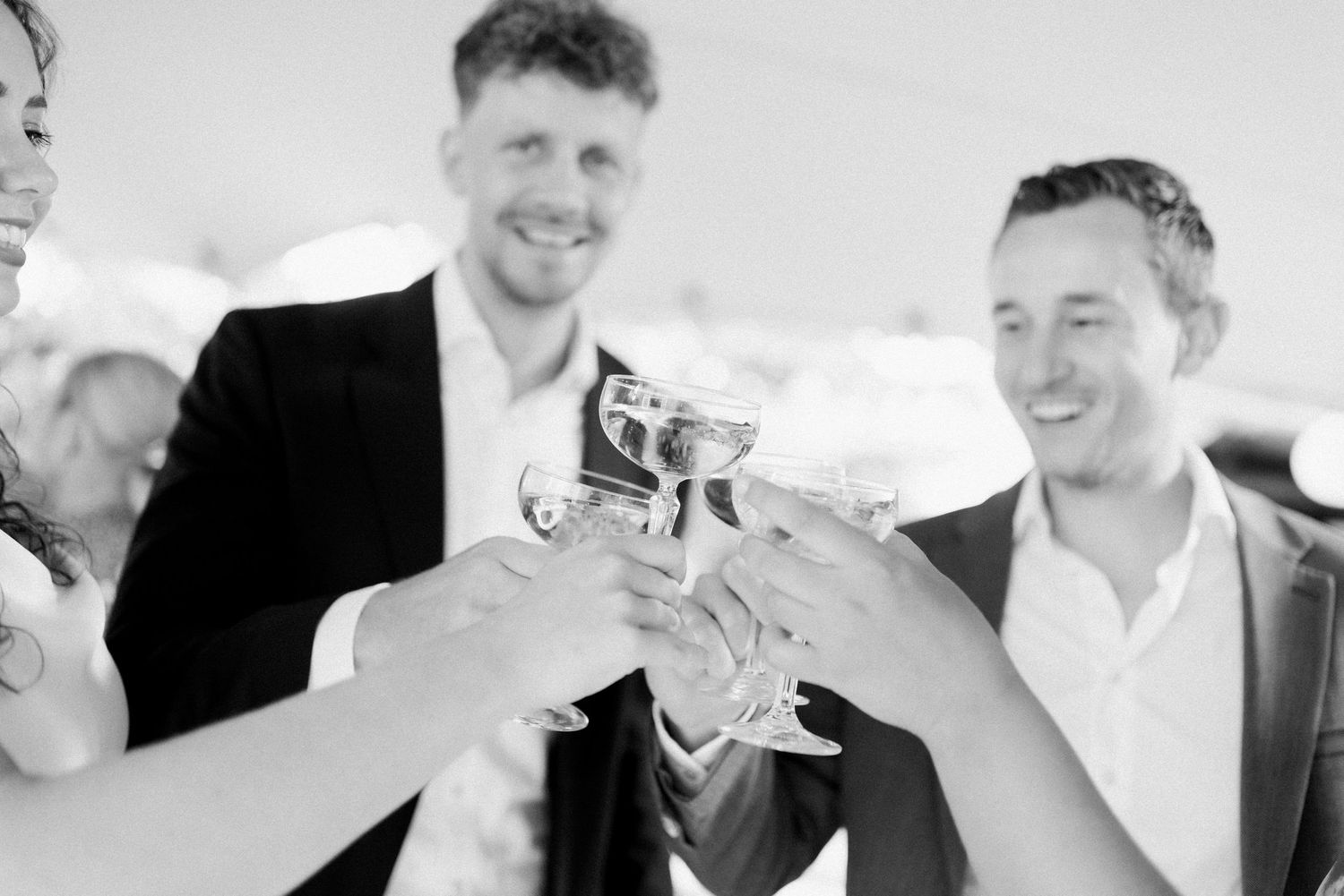 A black and white collage of candid moments showing people laughing and smiling together.