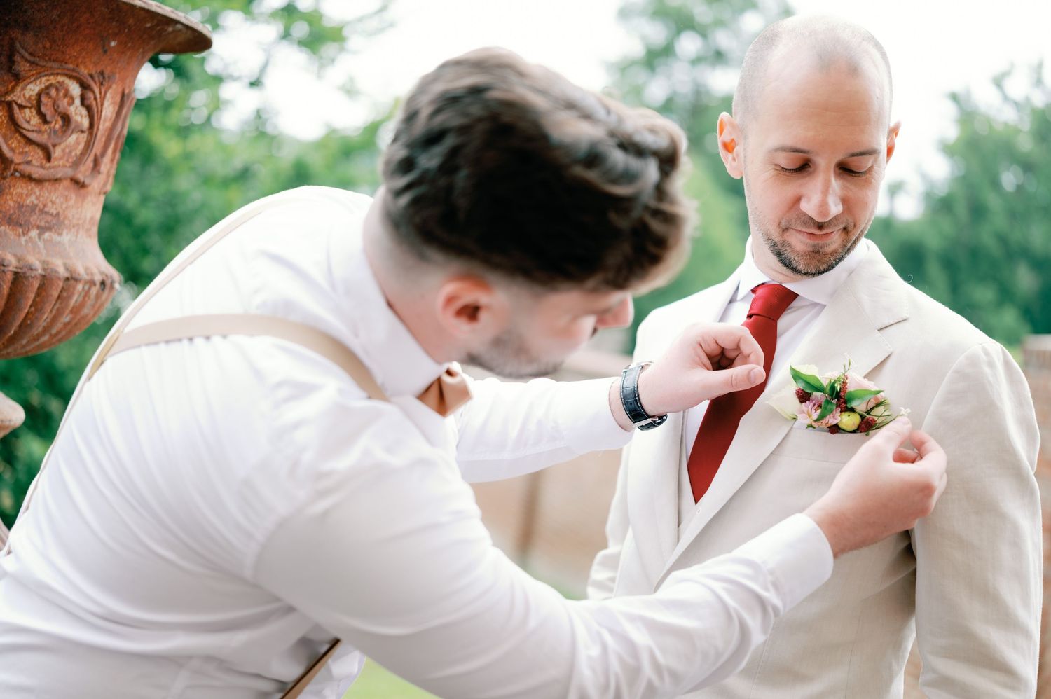 A series of photos showing wedding preparations with a boutonniere being pinned on a white suit jacket.