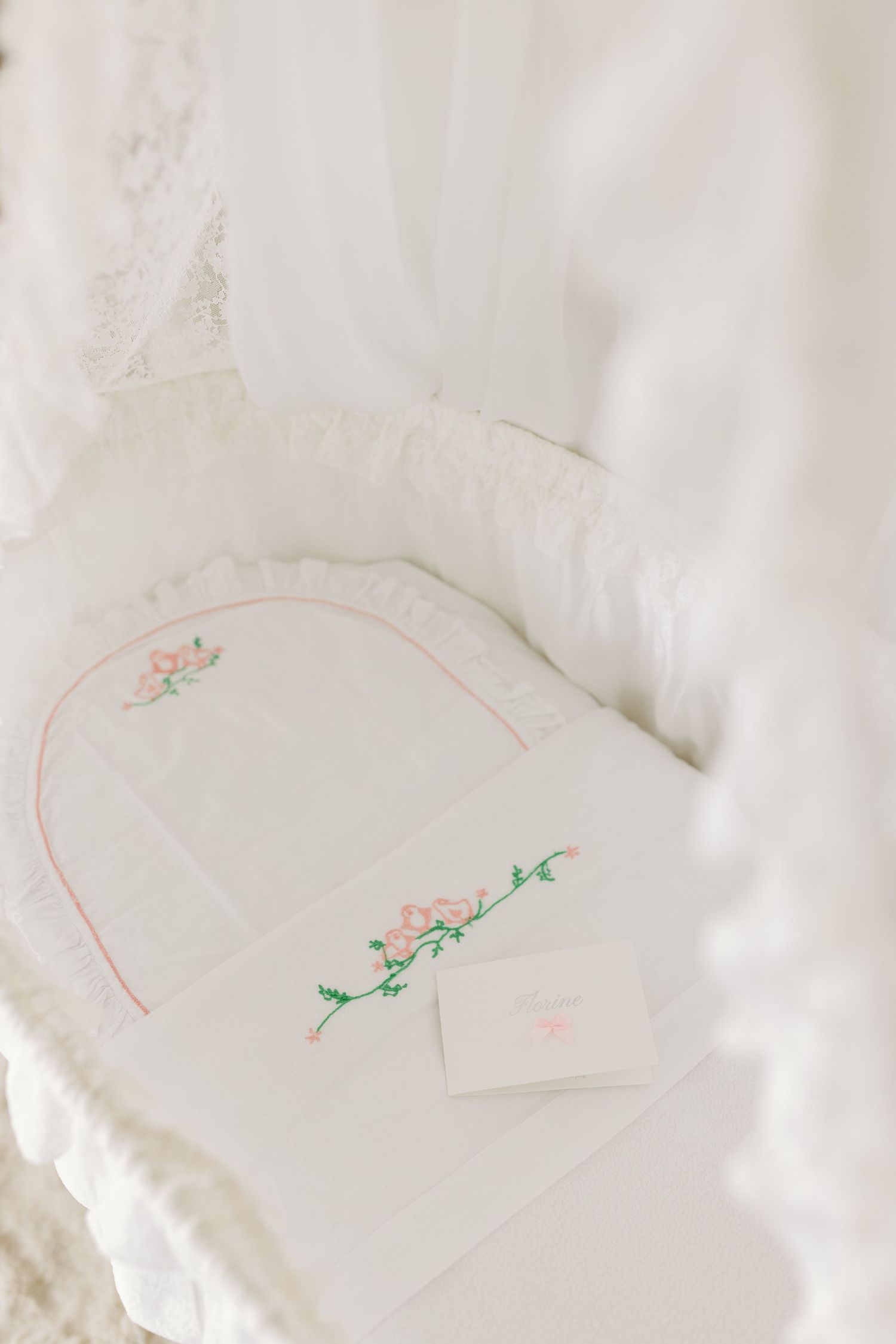 A series of four white paper napkins with minimalist floral designs sketched in red and green ink.