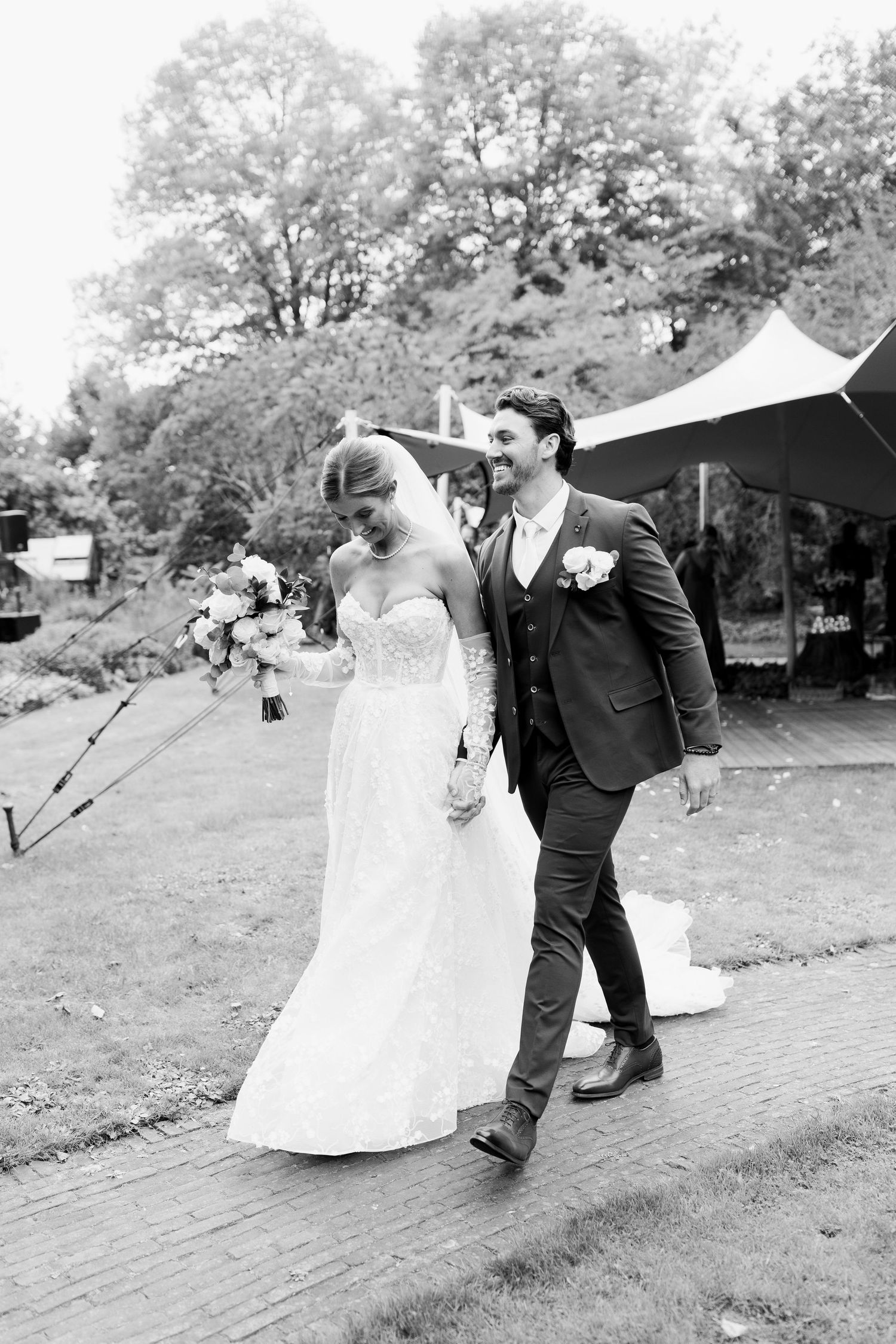 A romantic black and white wedding sequence shows a couple dancing and dipping in an outdoor garden setting.