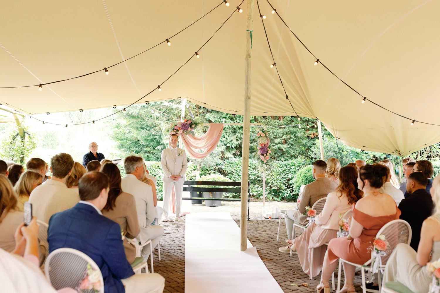 A series of wedding reception photos showing guests seated under white tents during an outdoor celebration.