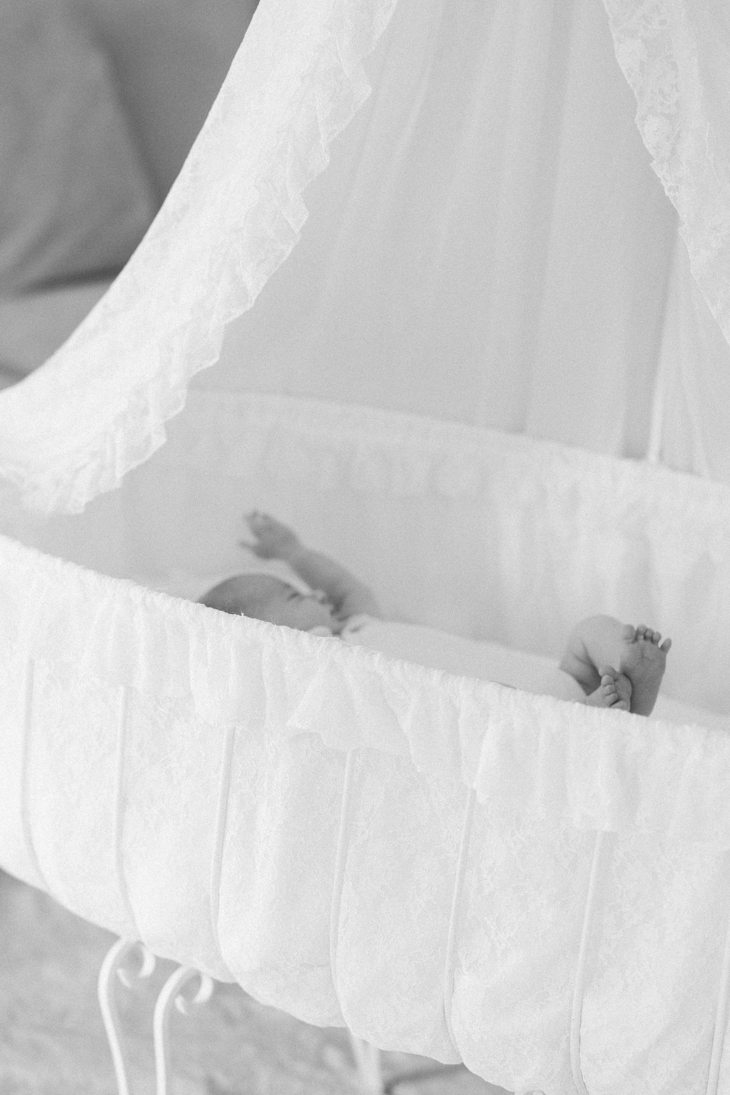 Close-up view of delicate white lace and tulle fabric details from a wedding dress or formal gown.