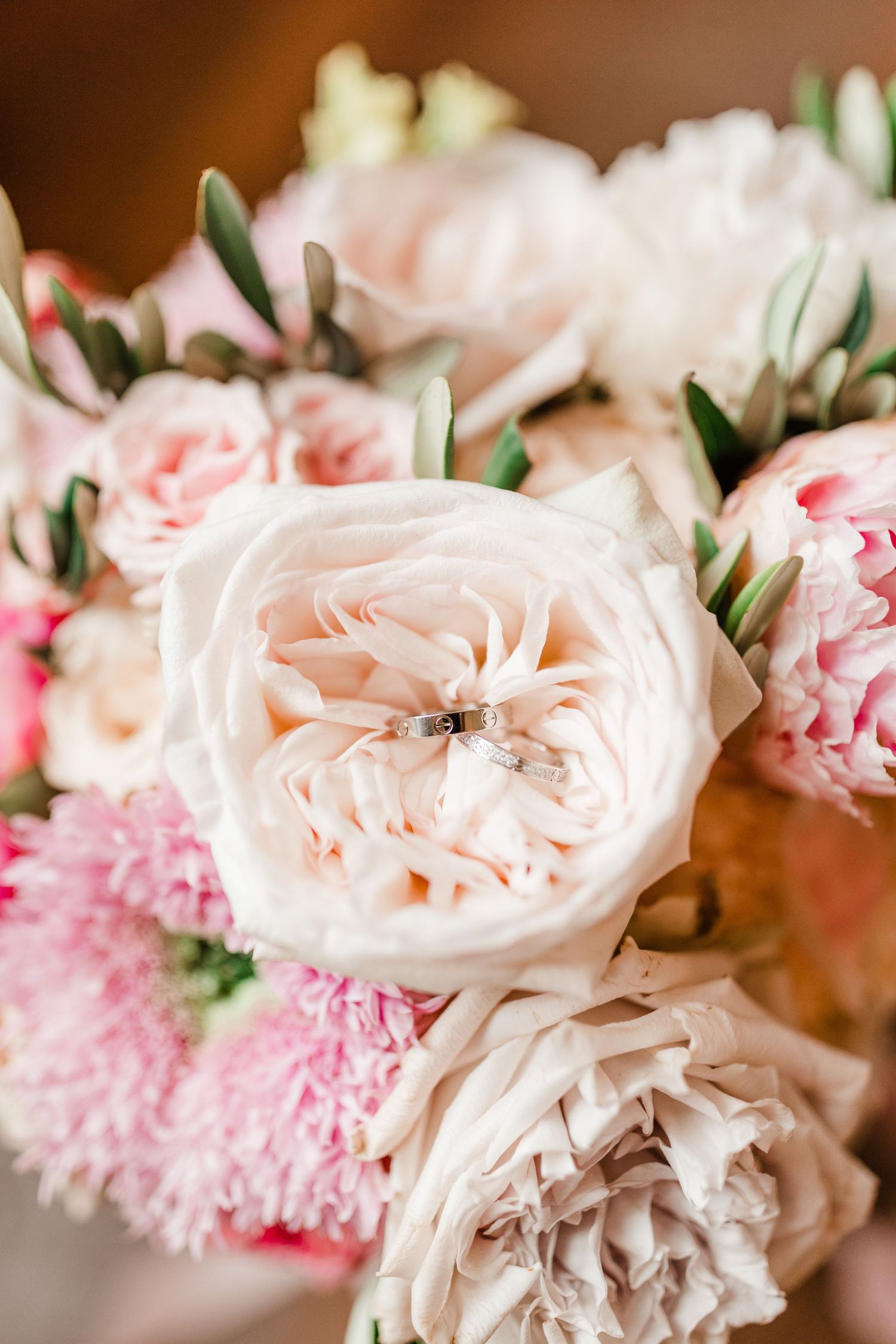 Close-up of delicate pink and blush roses with soft petals in a floral arrangement.
