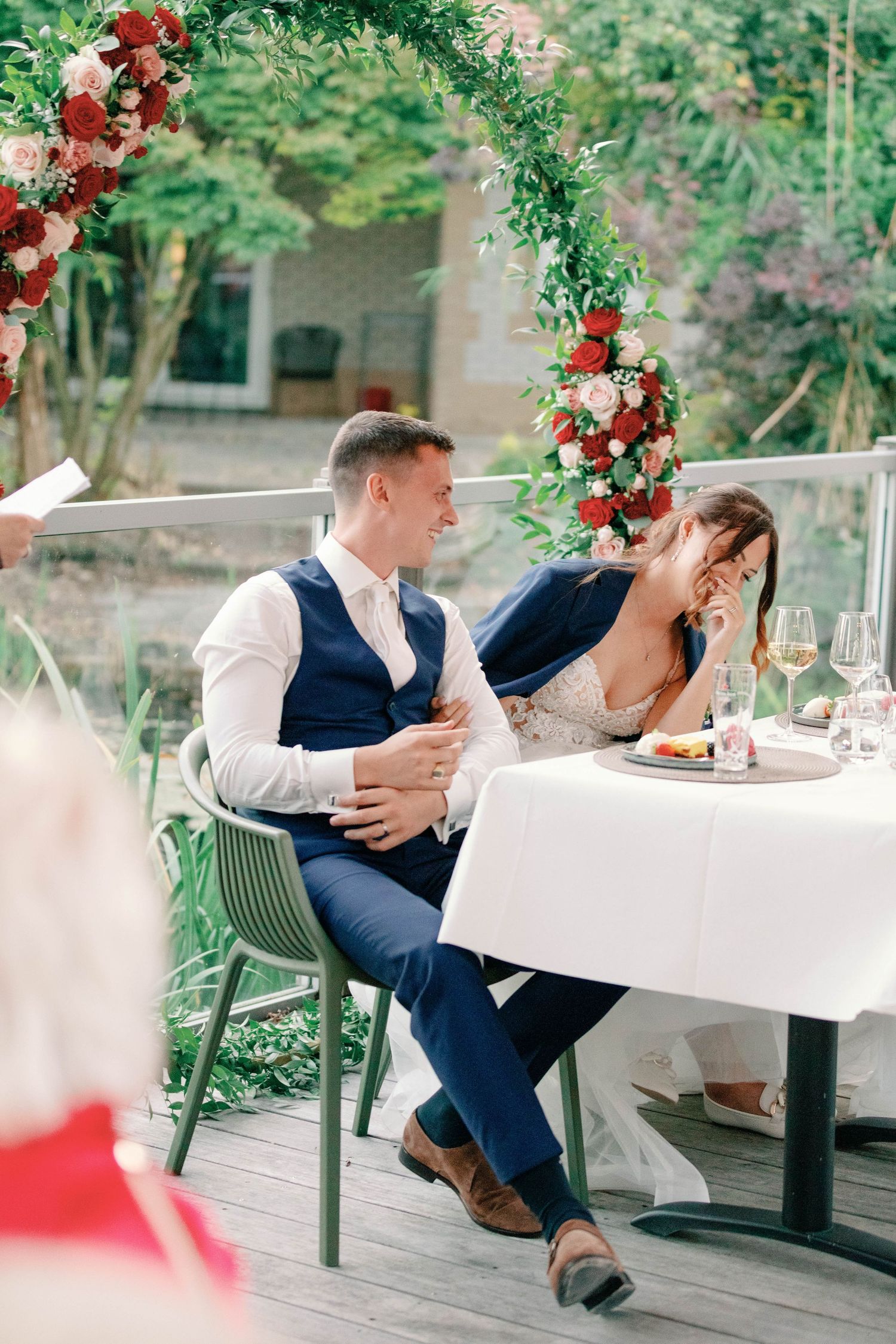 Emotional moment between guests at outdoor wedding reception.