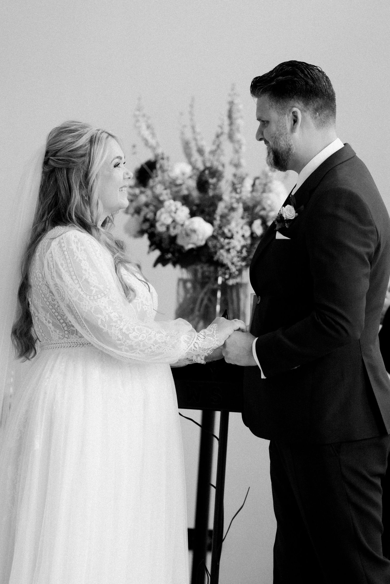 A wedding couple shares a romantic first dance moment in a sequence of black and white photographs.