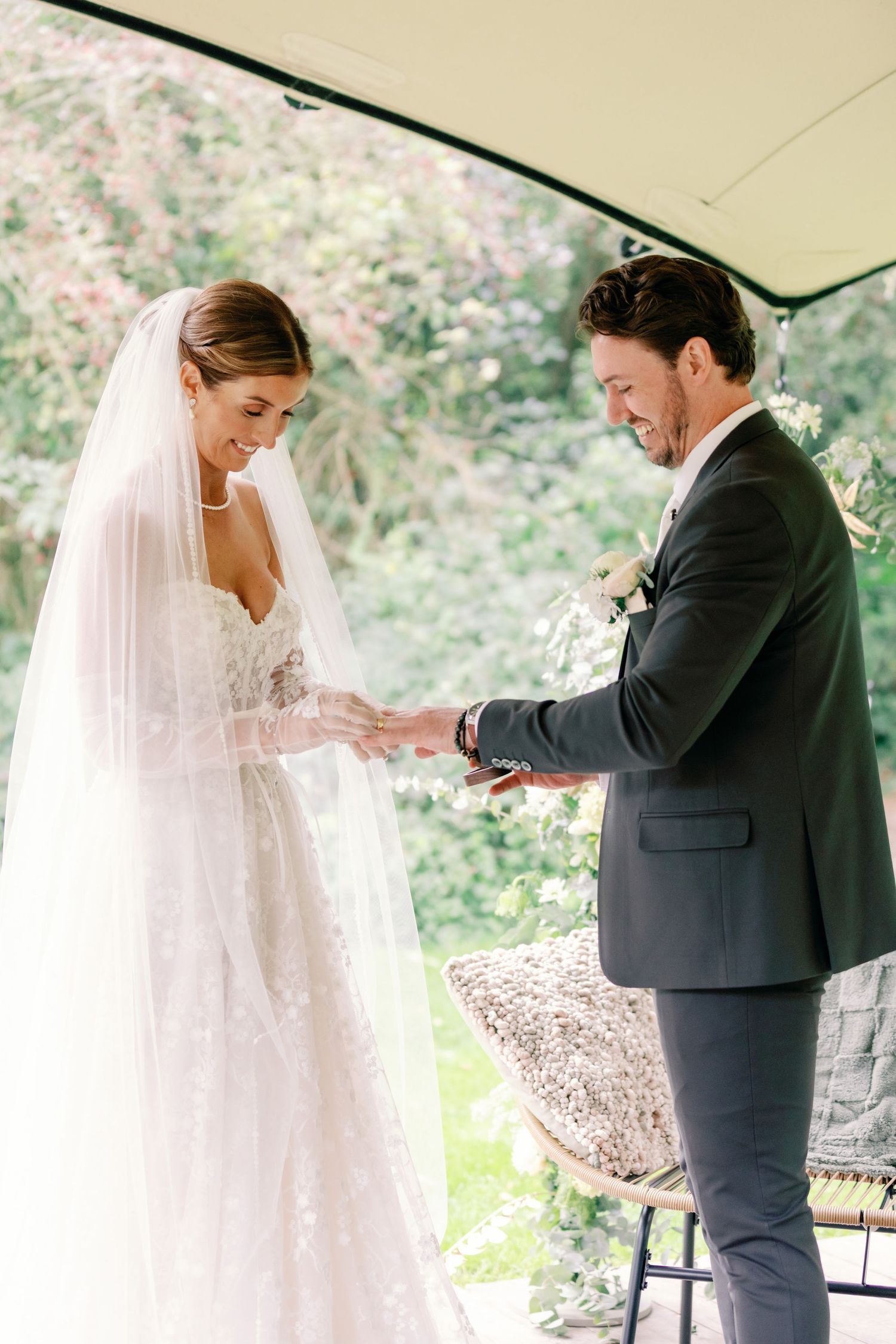 A series of photos showing a touching ring exchange moment during an outdoor wedding ceremony.