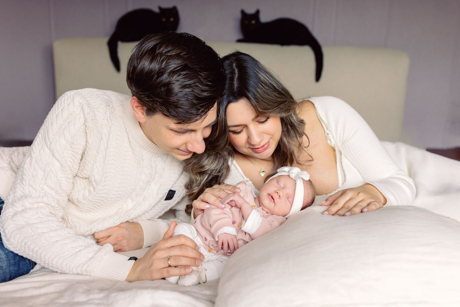 Family members sharing intimate moments while resting together on a bed.
