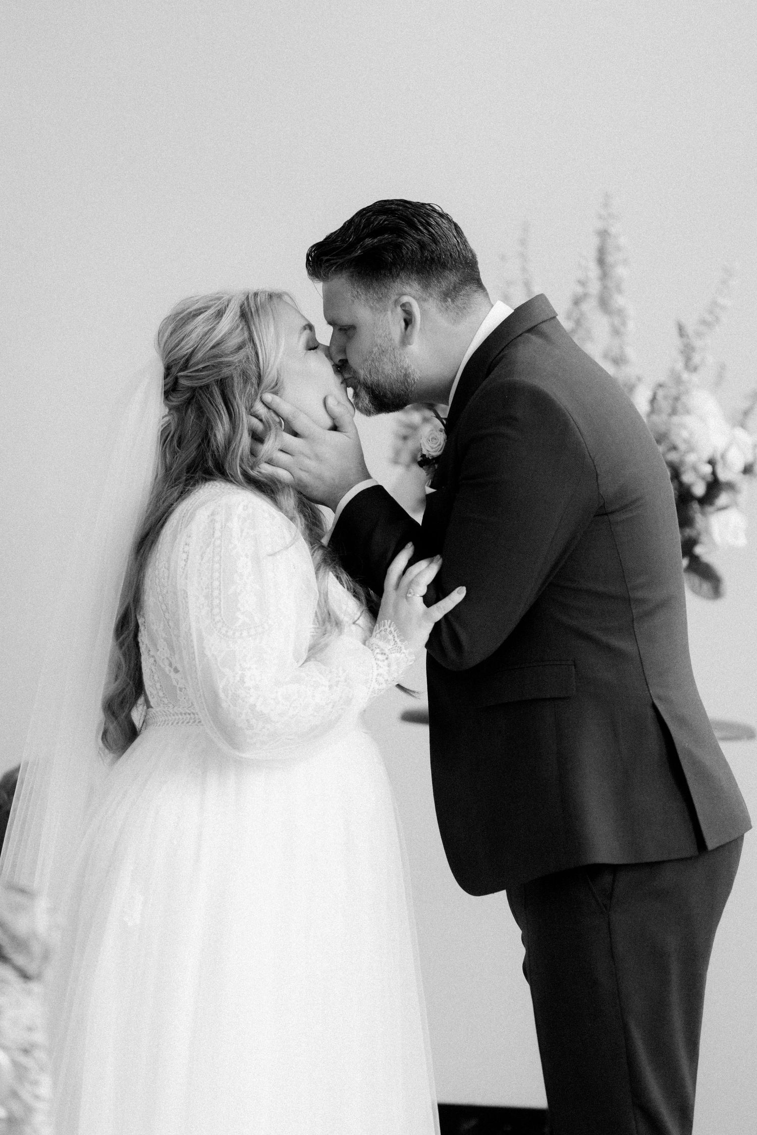 A romantic wedding sequence shows a couple sharing their first kiss in multiple artistic black and white photographs.
