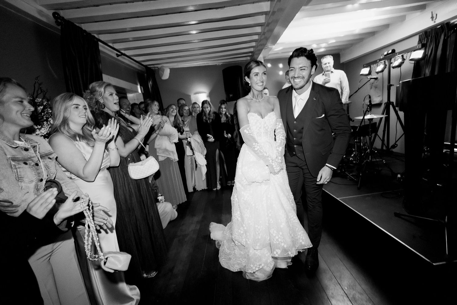 Black and white wedding reception photos showing dancing and celebration on the dance floor at night.