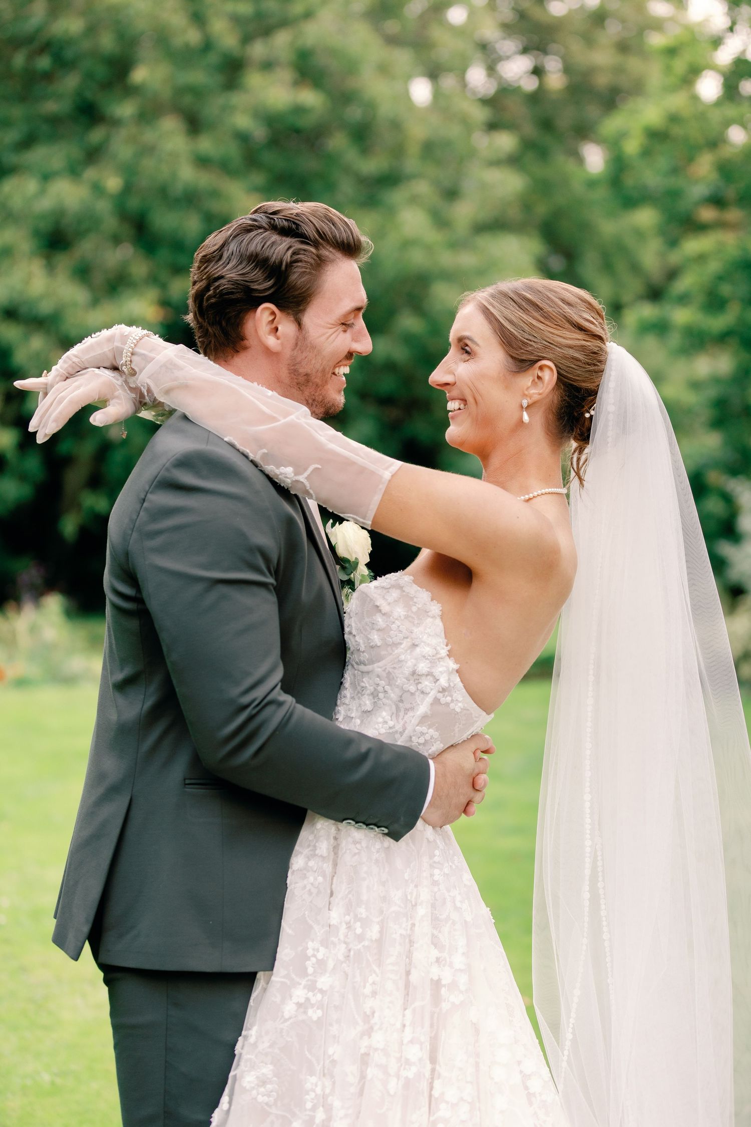 A romantic first dance sequence between newlyweds on their wedding day in a lush garden setting.