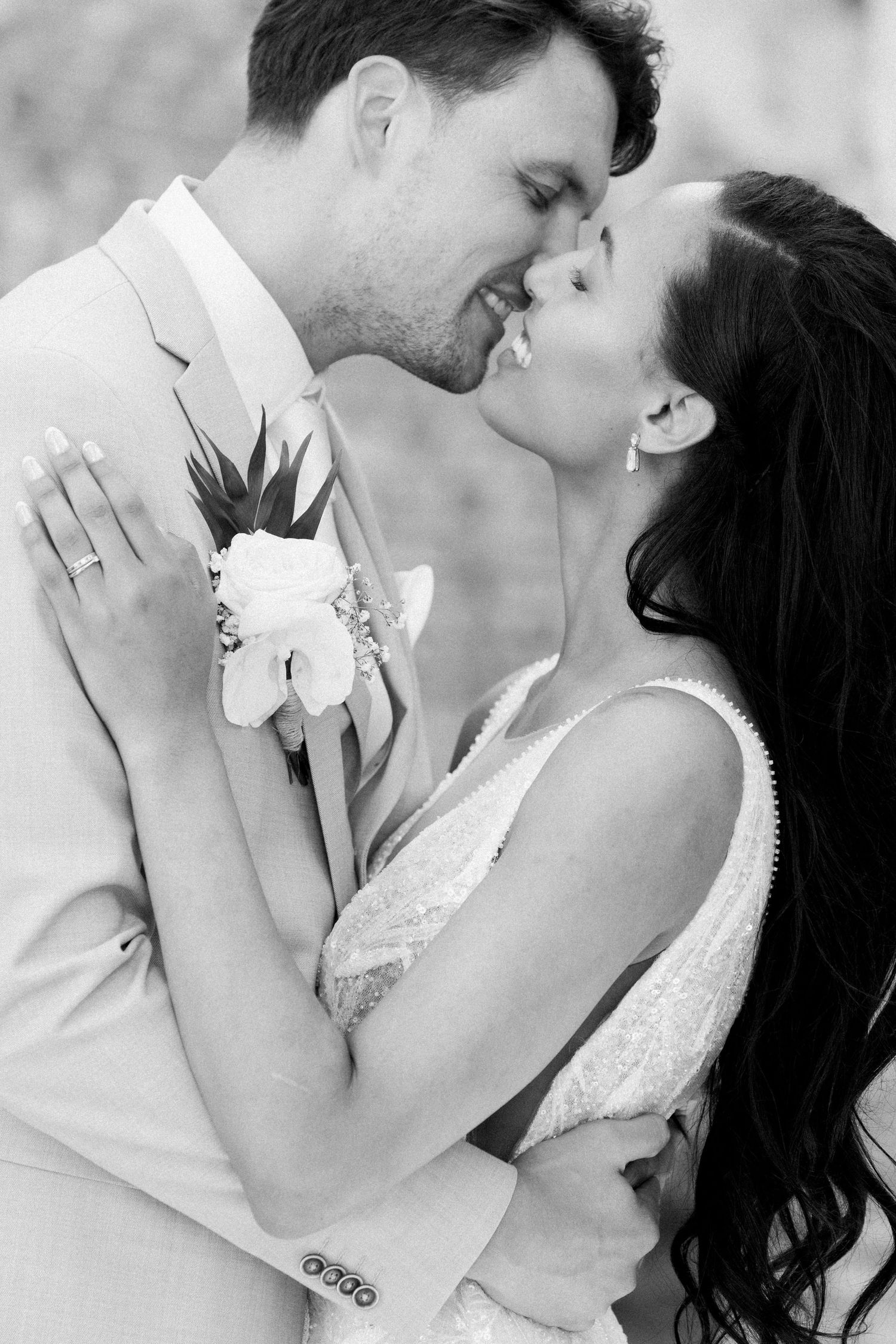 A romantic black and white photo sequence shows a couple in wedding attire sharing tender kisses.