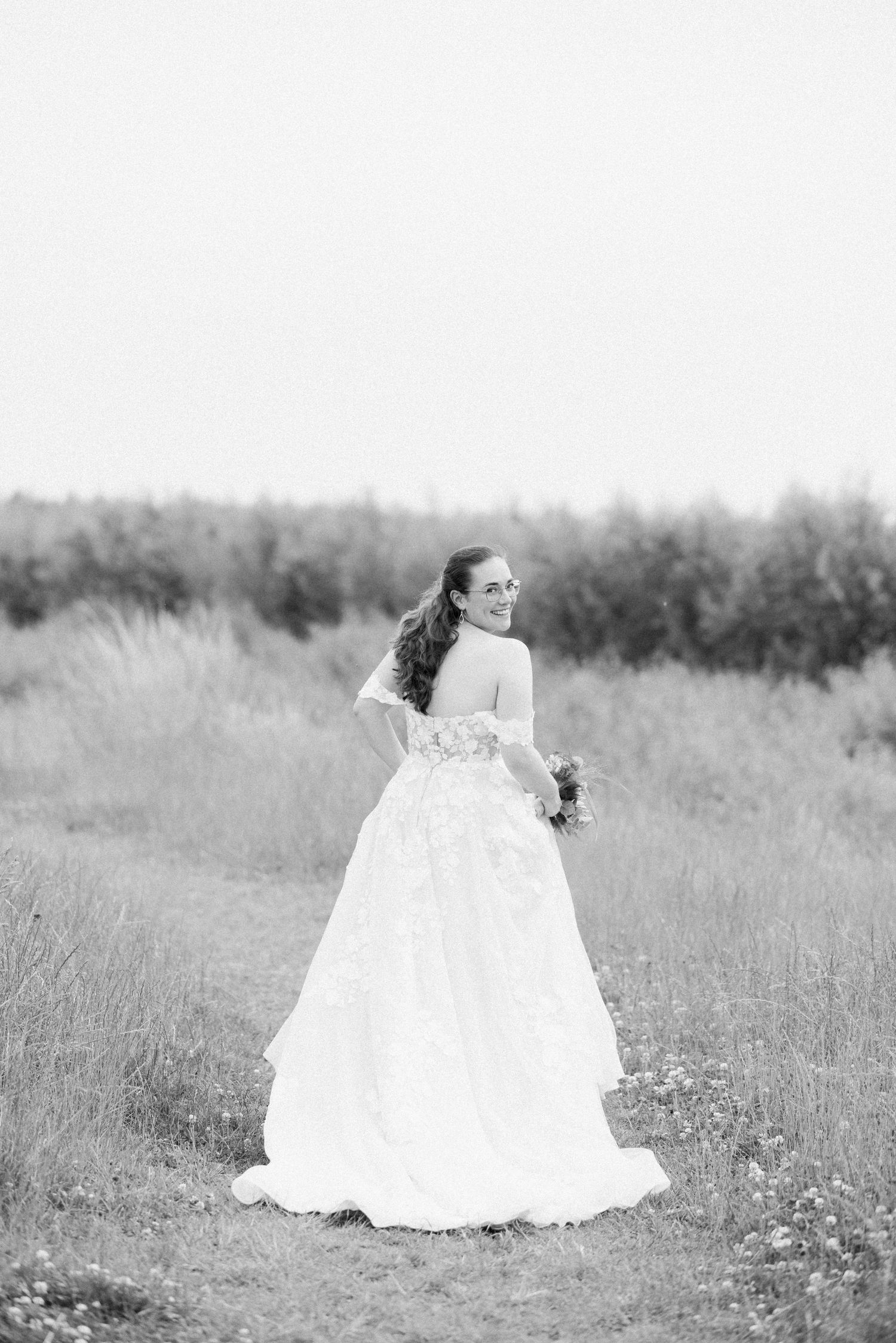 Ethereal black and white bridal portraits in a dreamy meadow setting.