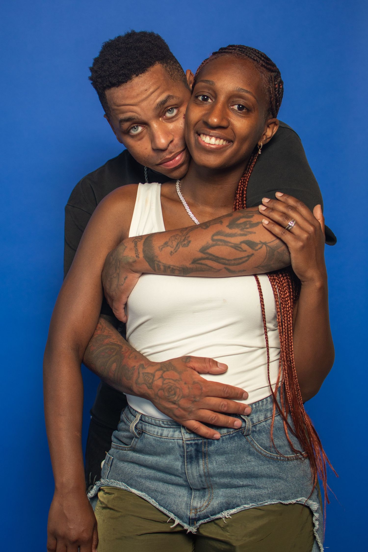 Two people embrace intimately against a bright blue background in a series of tender poses.