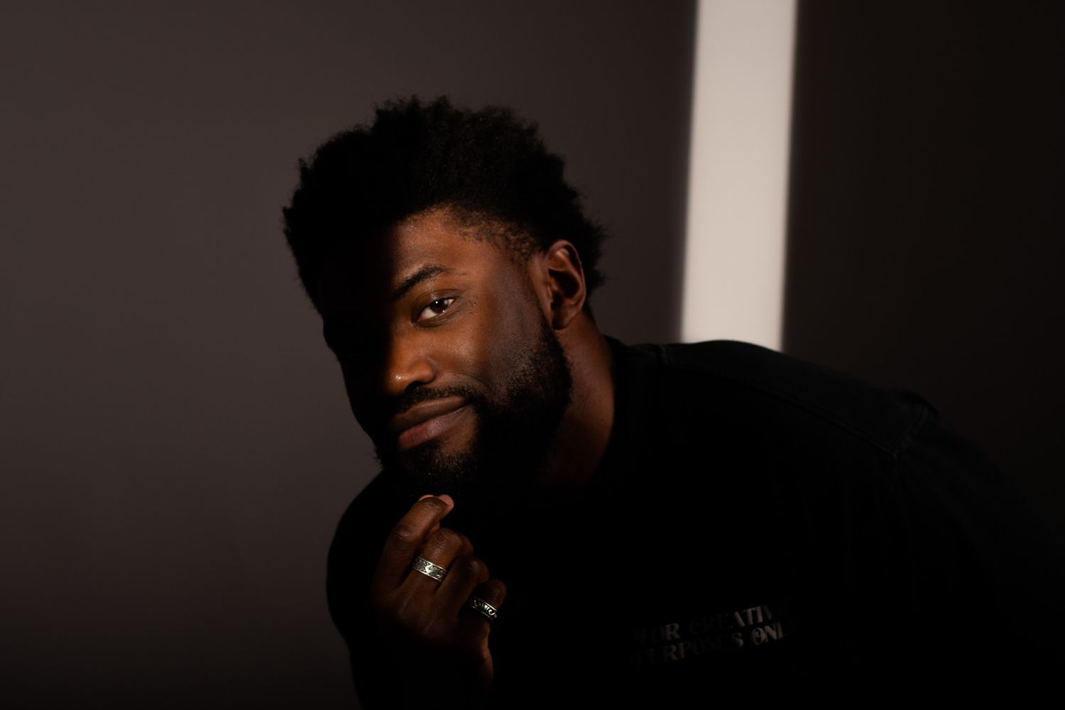Dramatic low-key studio portraits showing expressive poses against dark background.