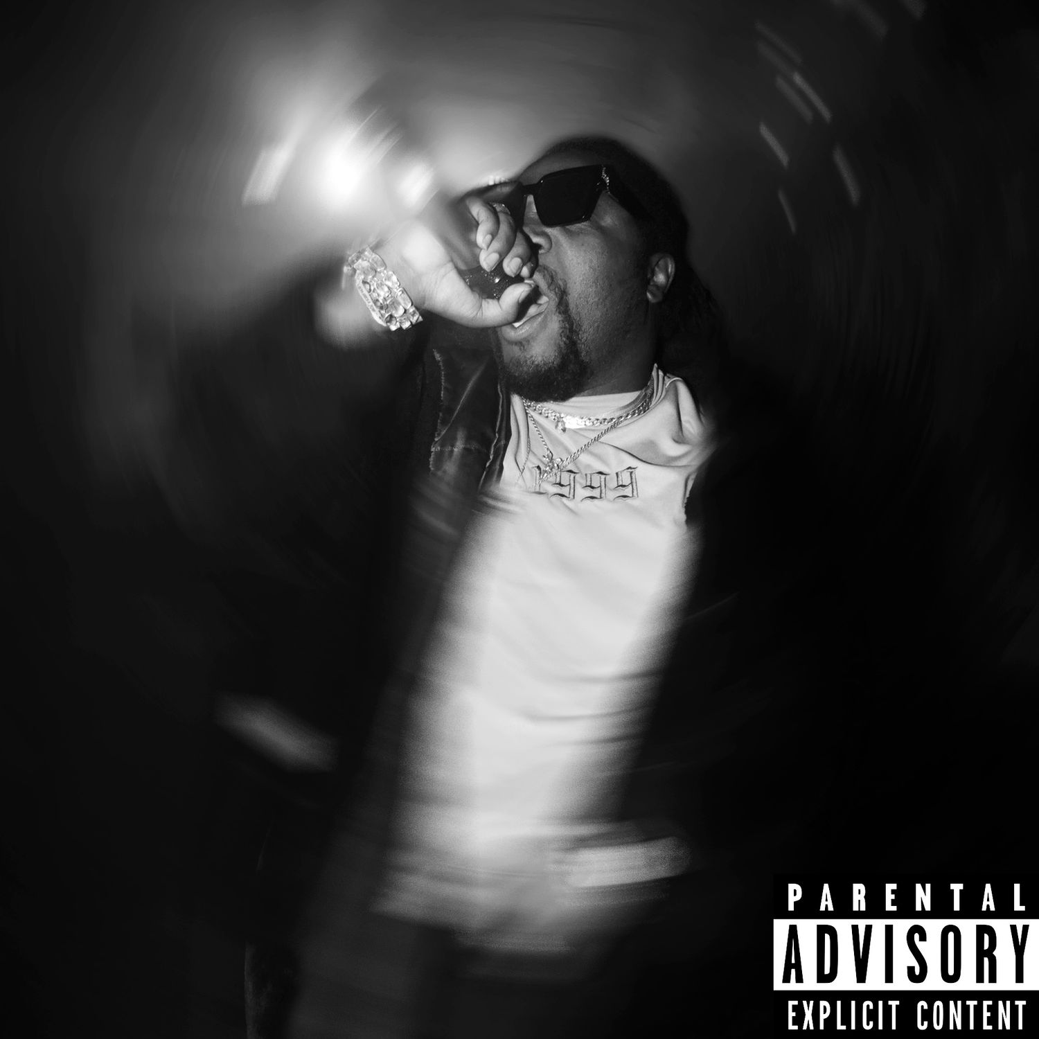 Black and white promotional image with dramatic lighting and parental advisory label.