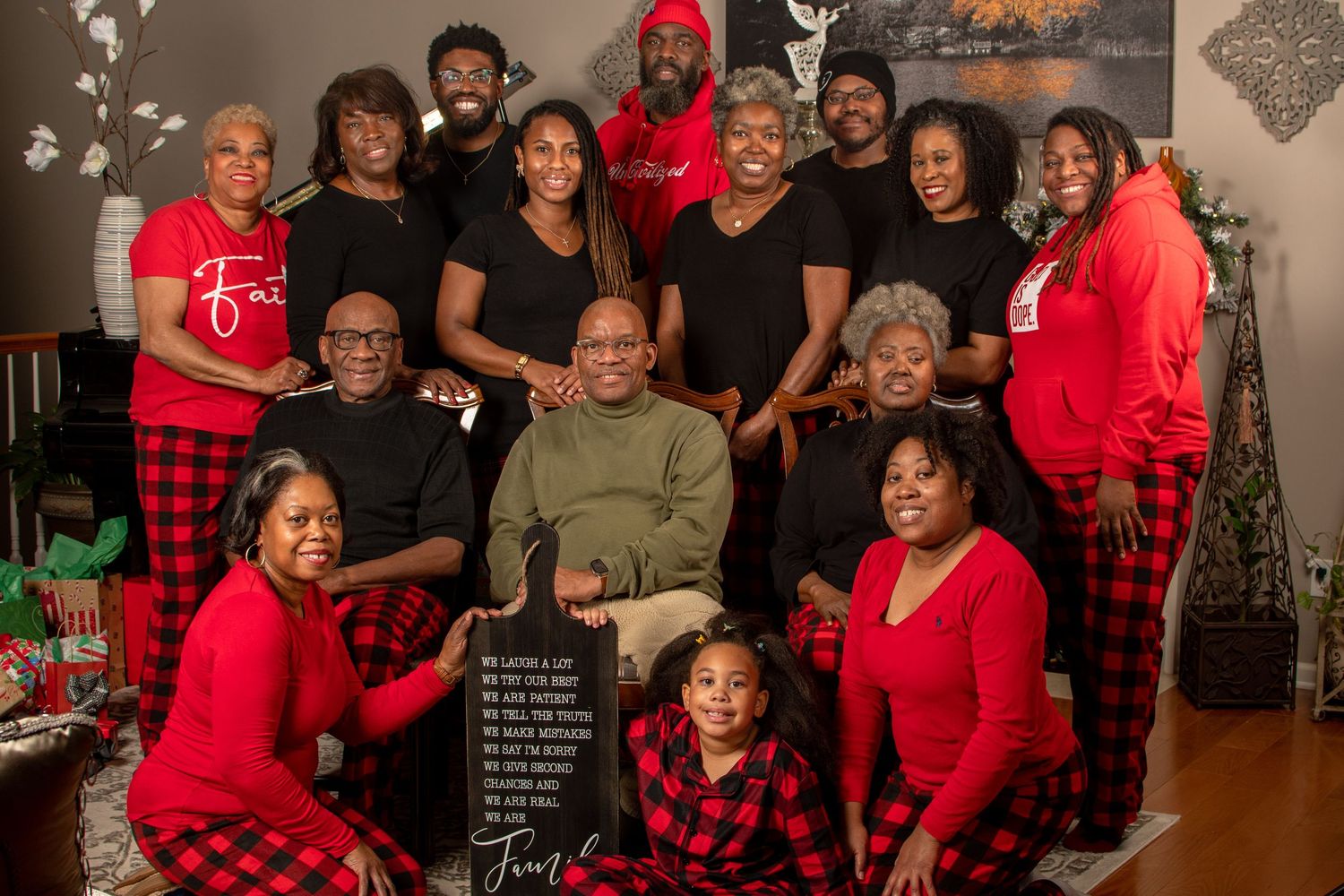 Large family group photo with everyone wearing matching holiday pajamas and festive attire.