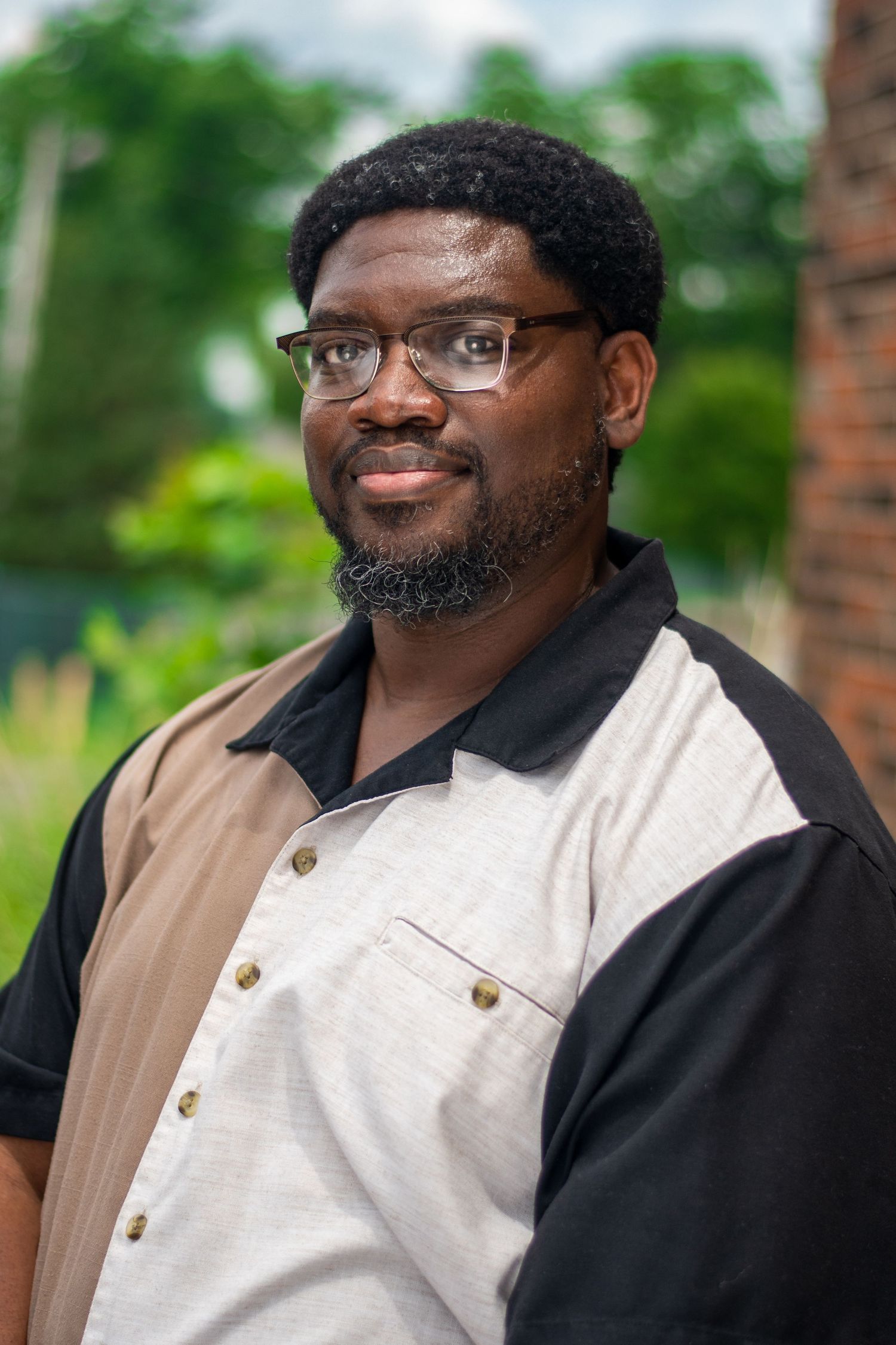 Professional headshots showing friendly expressions while wearing business casual attire outdoors.