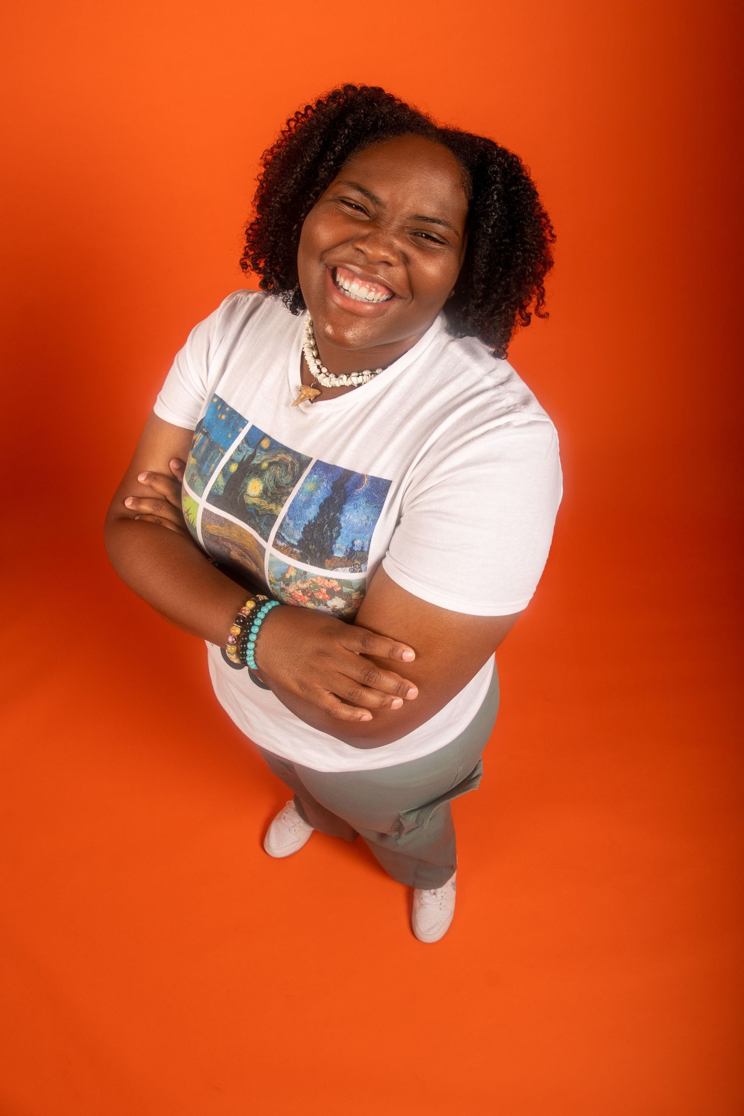 A series of portrait photos against an orange background showing joyful expressions and casual white t-shirt attire.