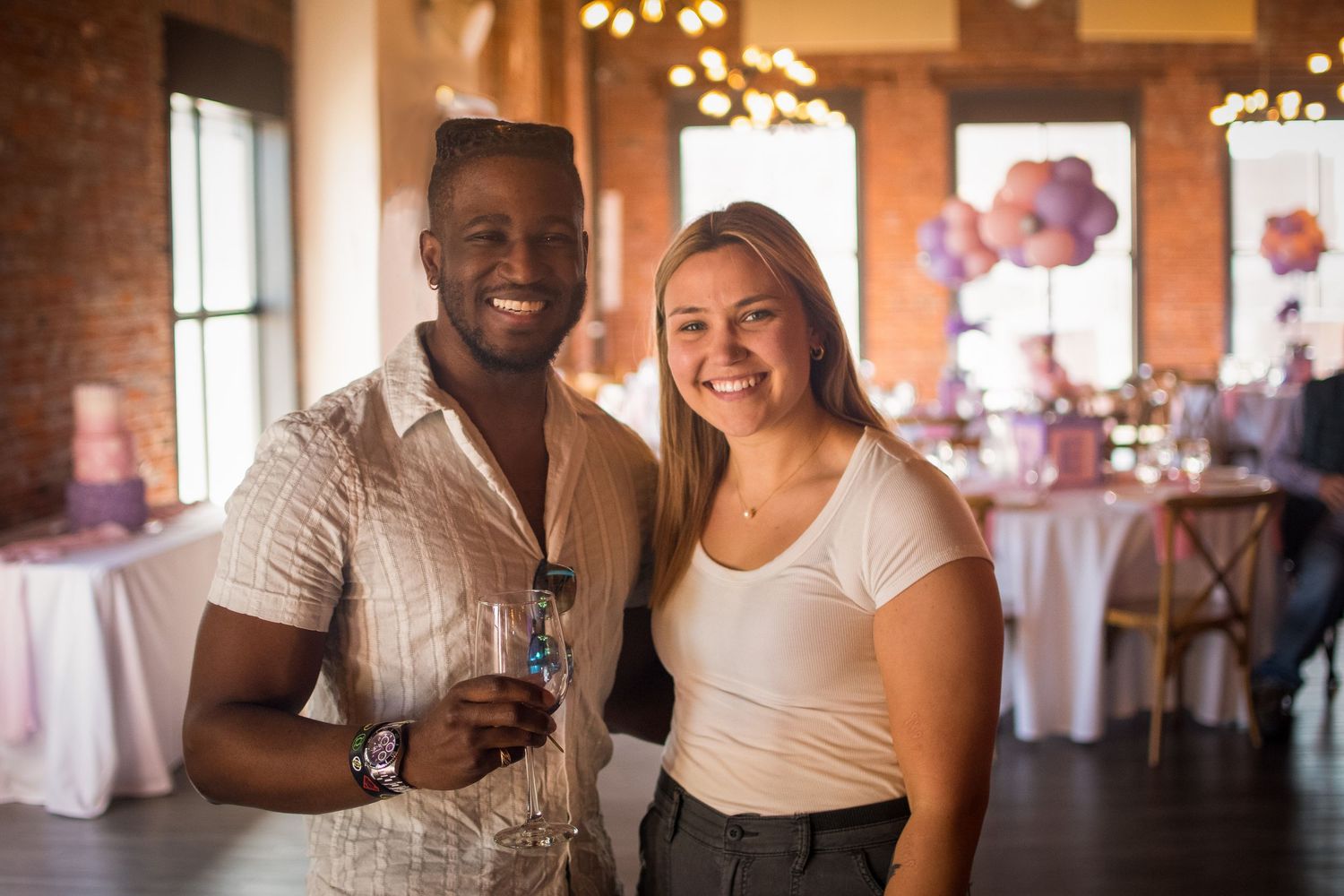 A couple sharing a joyful moment together at an indoor celebration venue.