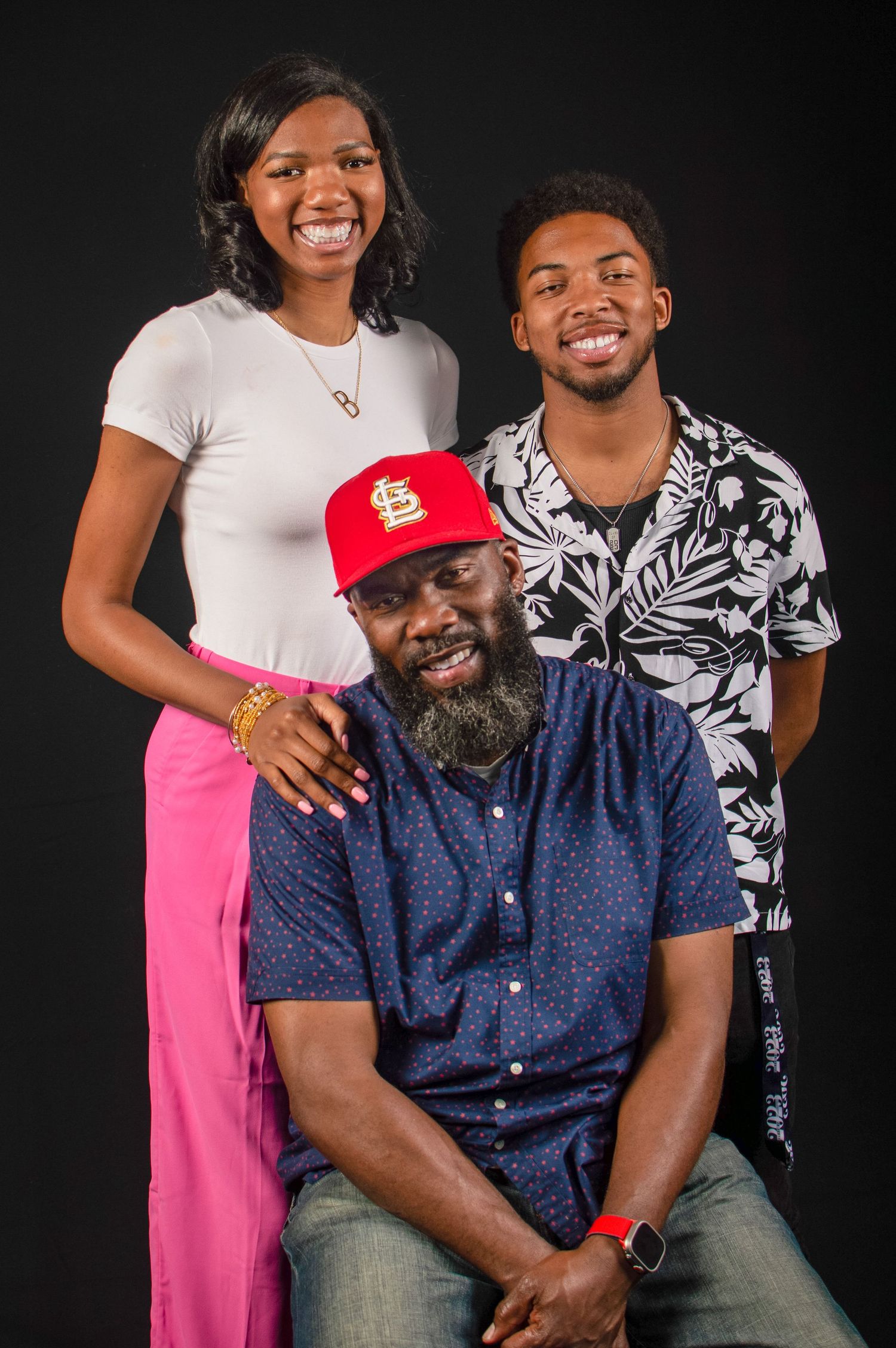Family portrait series showing joyful moments together against black background in coordinated casual outfits.
