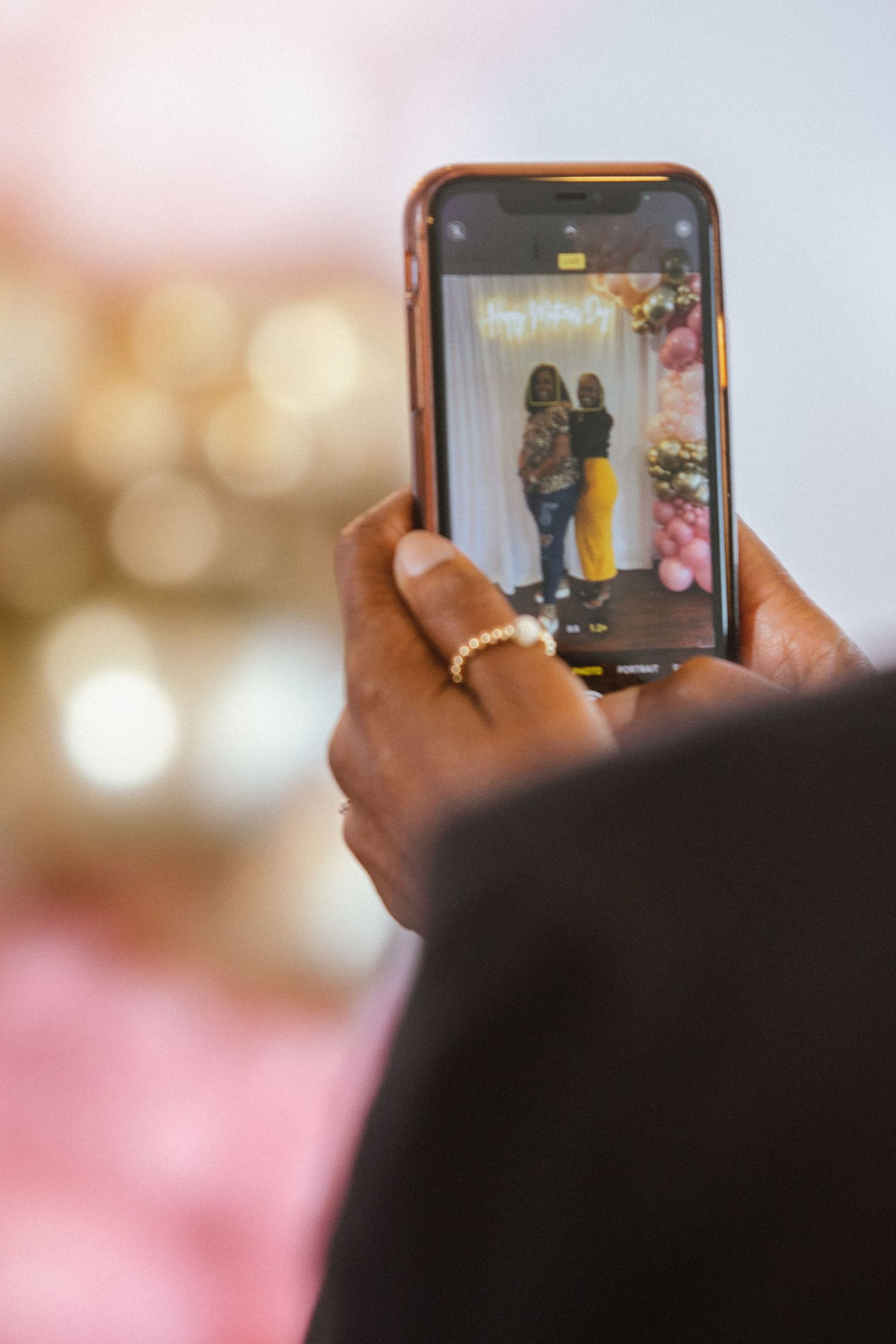 phone taking picture of two black women